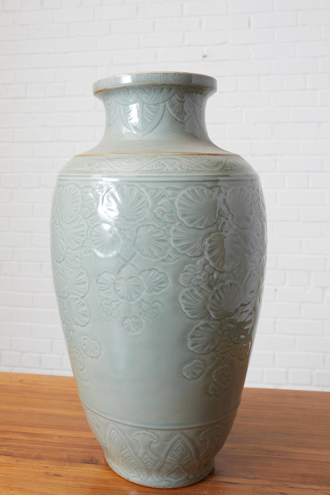 Large, Chinese Longquan style celadon vase with a stunning lotus leaf pattern underglaze and Greek key detail on the perimeter of the neck. Heavy Chinese porcelain vase that weighs nearly 40lbs.
  