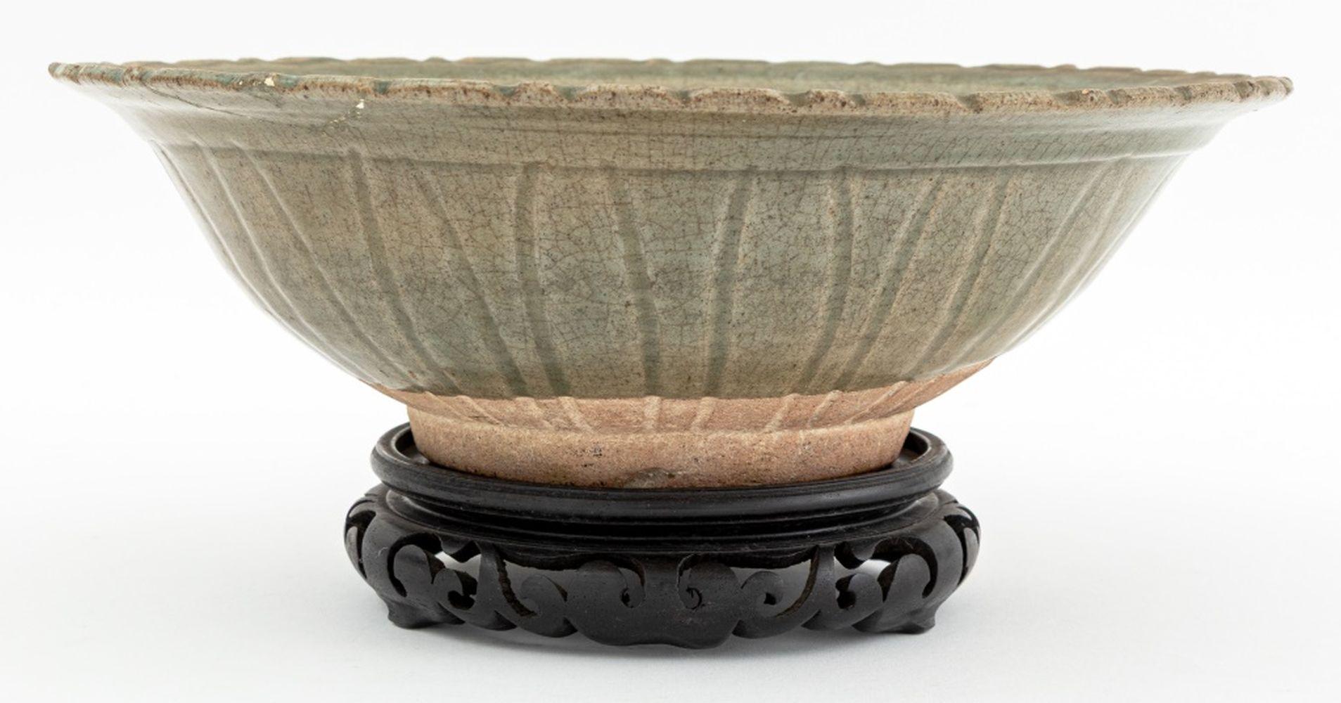 Chinese Lotus Form Longquan Celadon Glazed Bowl, on ebonized carved wood stand. 3.5