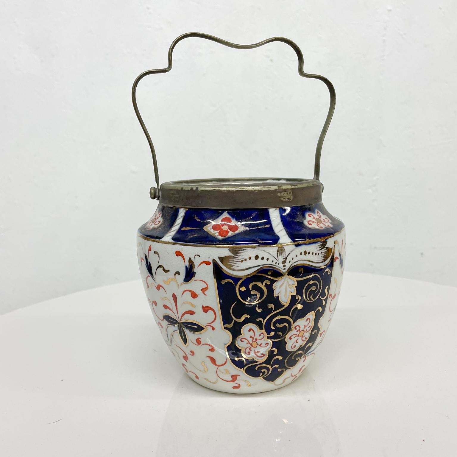 Decorative Vase
Chinese Pottery Lovely Lighthearted Hand Painted Pottery Vase Vessel signed Art
Features silverplated sculptural handle.
6 diameter 5.5 h, 9 h w/ handle
Original Vintage unrestored damaged condition: it has a hairline crack at