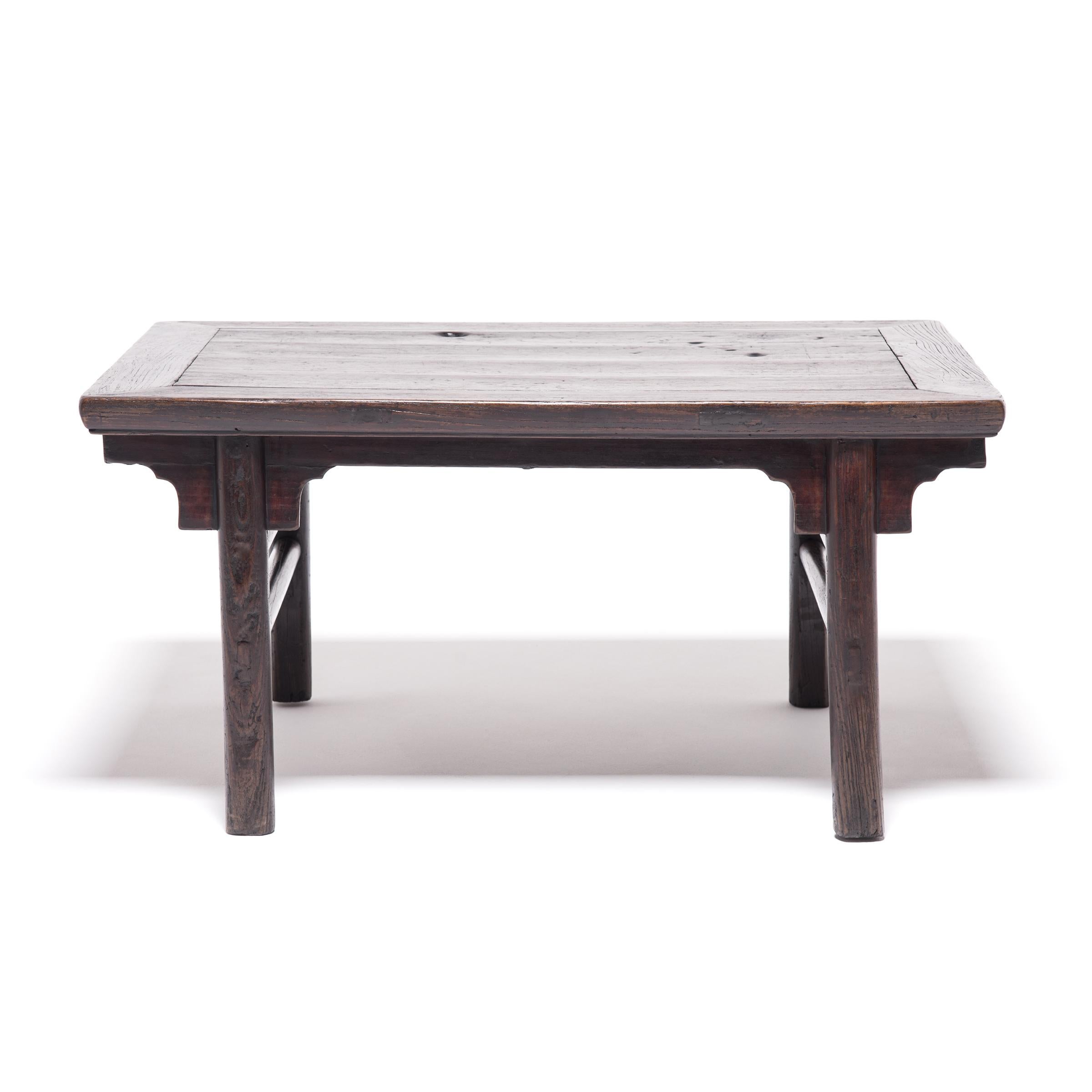 This low, rectangular table would have once flanked a platform bed in the intimate living space of a traditional Qing-dynasty home. Perfectly proportioned, the table is a quintessential example of Chinese furniture design. The inset, rounded legs,