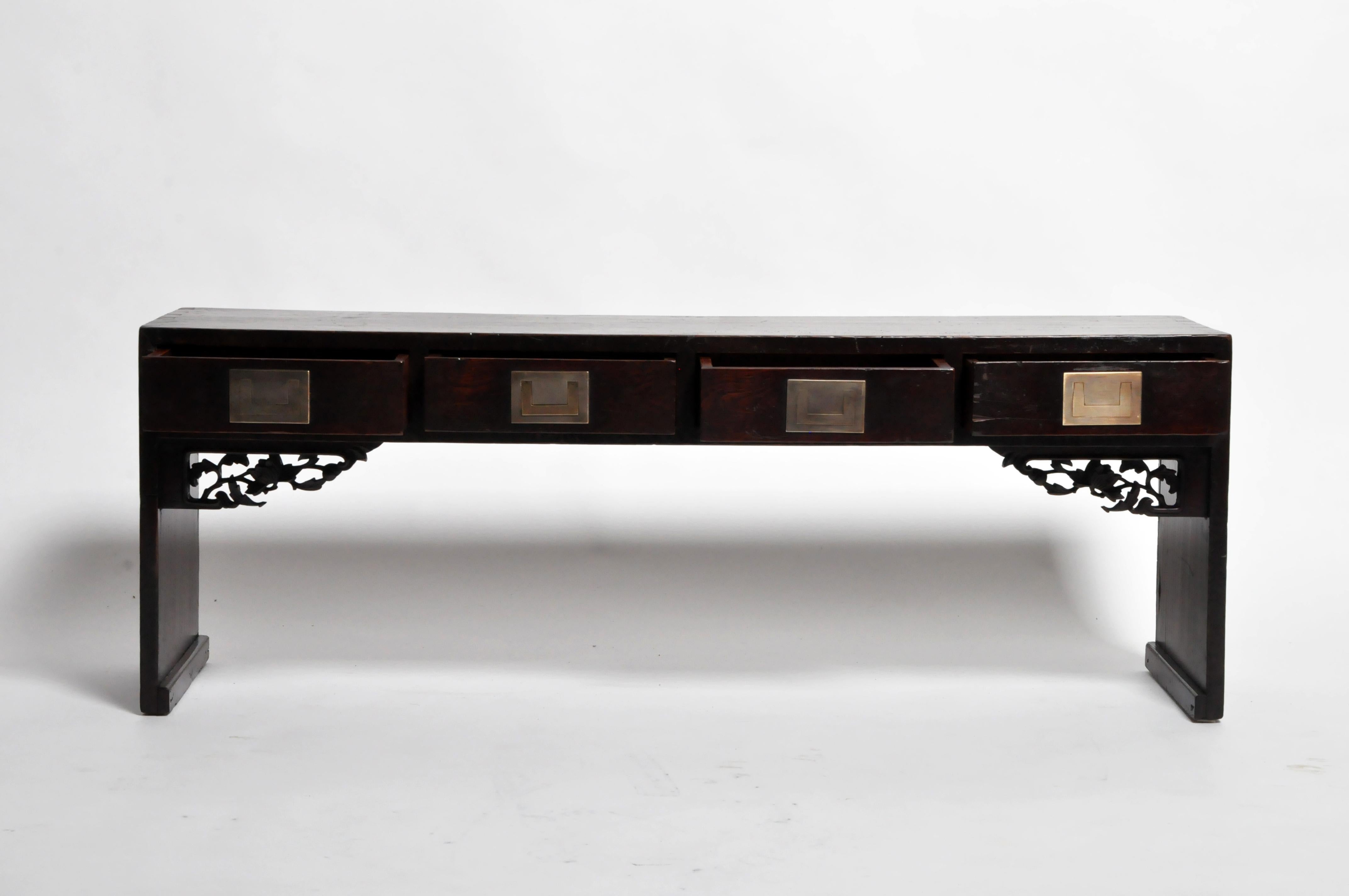 This exceptional table features row of drawers with exquisite flush-handled brass pulls. Large and finely chiseled dovetail joints gracefully connect the top and side legs. Delicate stretchers in a floral motif provide a curvaceous counterpoint to