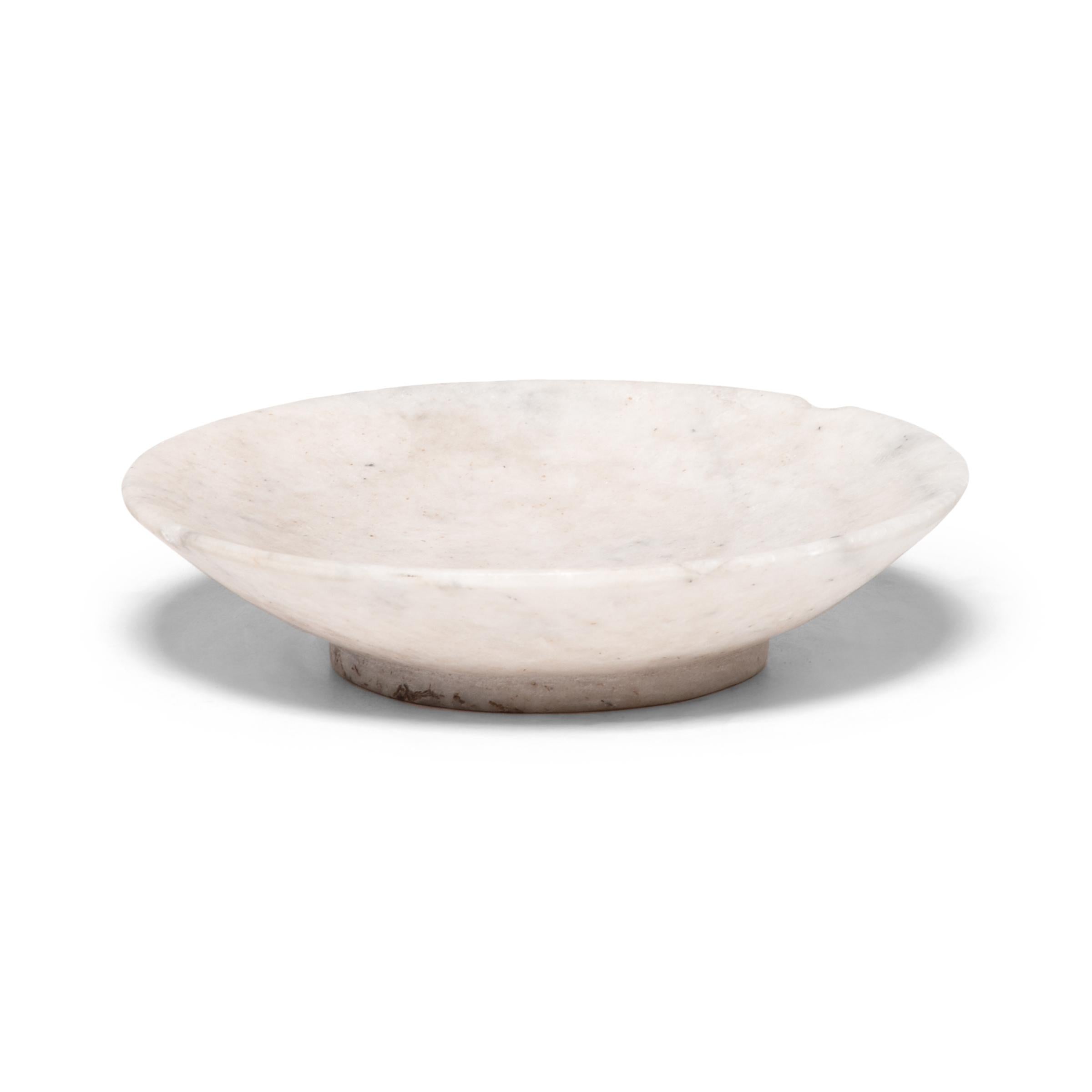 This hand carved marble dish from northern China is modeled after the delicate forms of footed porcelain rice bowls. Carefully worked with a smooth finish, the shallow plate is perfect as a vide-poche for jewelry and precious smalls.