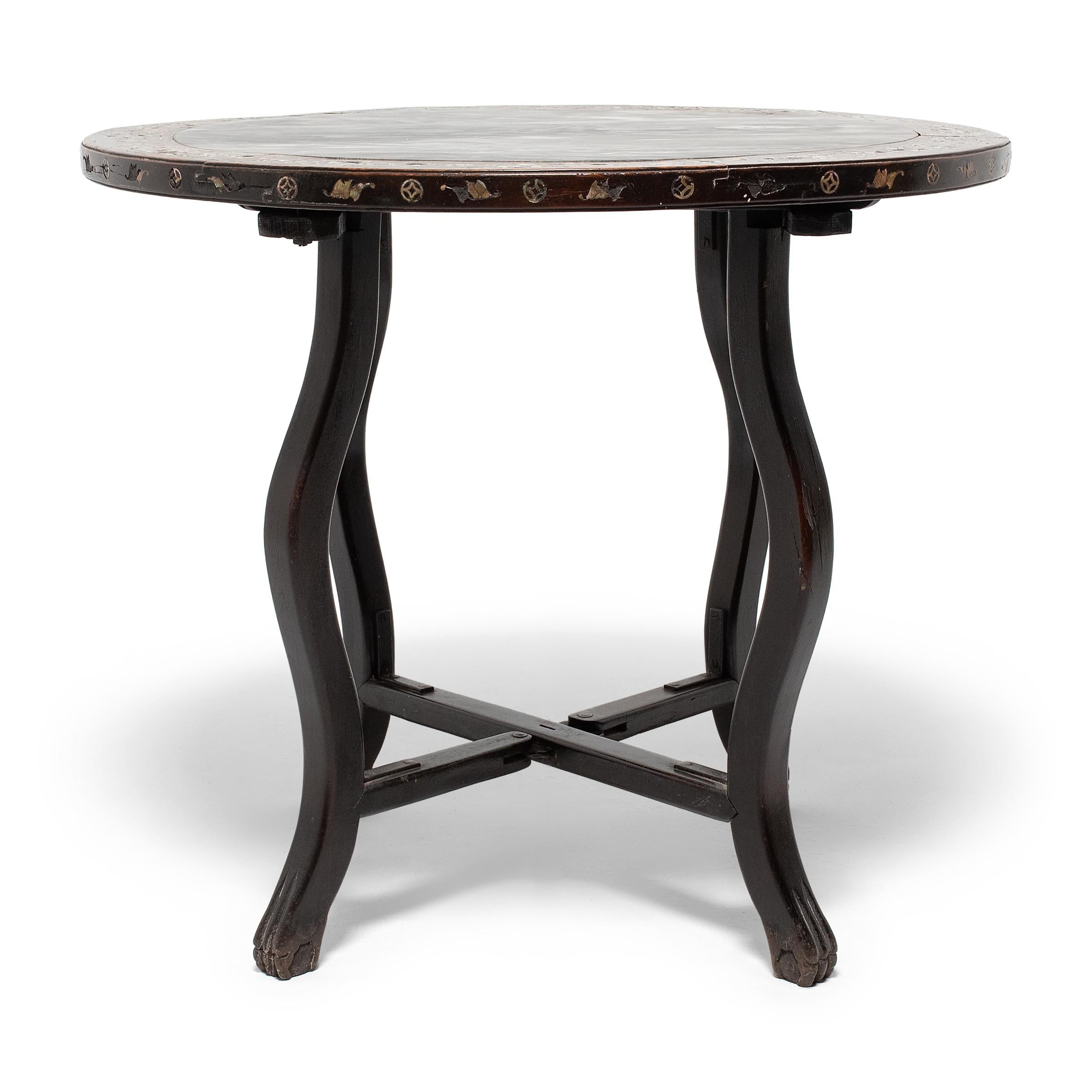 This gorgeous center table from the early 20th century applies classical Chinese forms to Western designs, and may have been intended for the export market. The table features a round top and four elegantly curved legs linked by interlocking