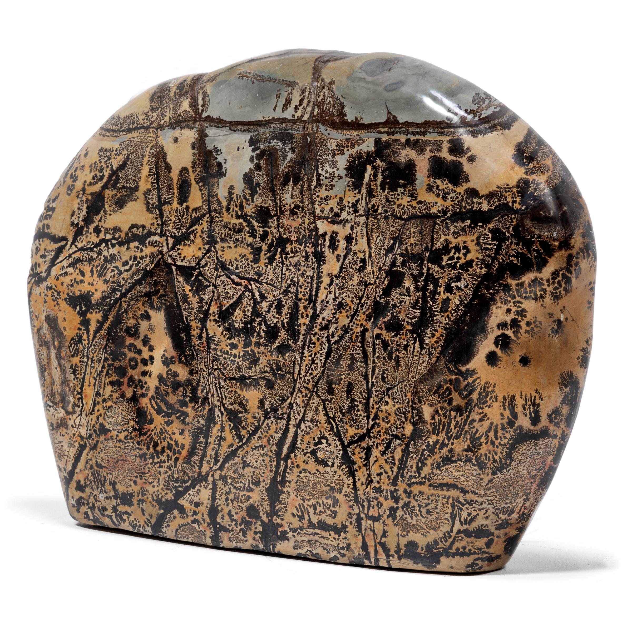 As if brushed with ink and inscribed with intricate calligraphy, this polished painting stone from Guangxi province is marked with swirling patterns of dark and light. To follow the stone's marbled coloring and natural veining can be deeply