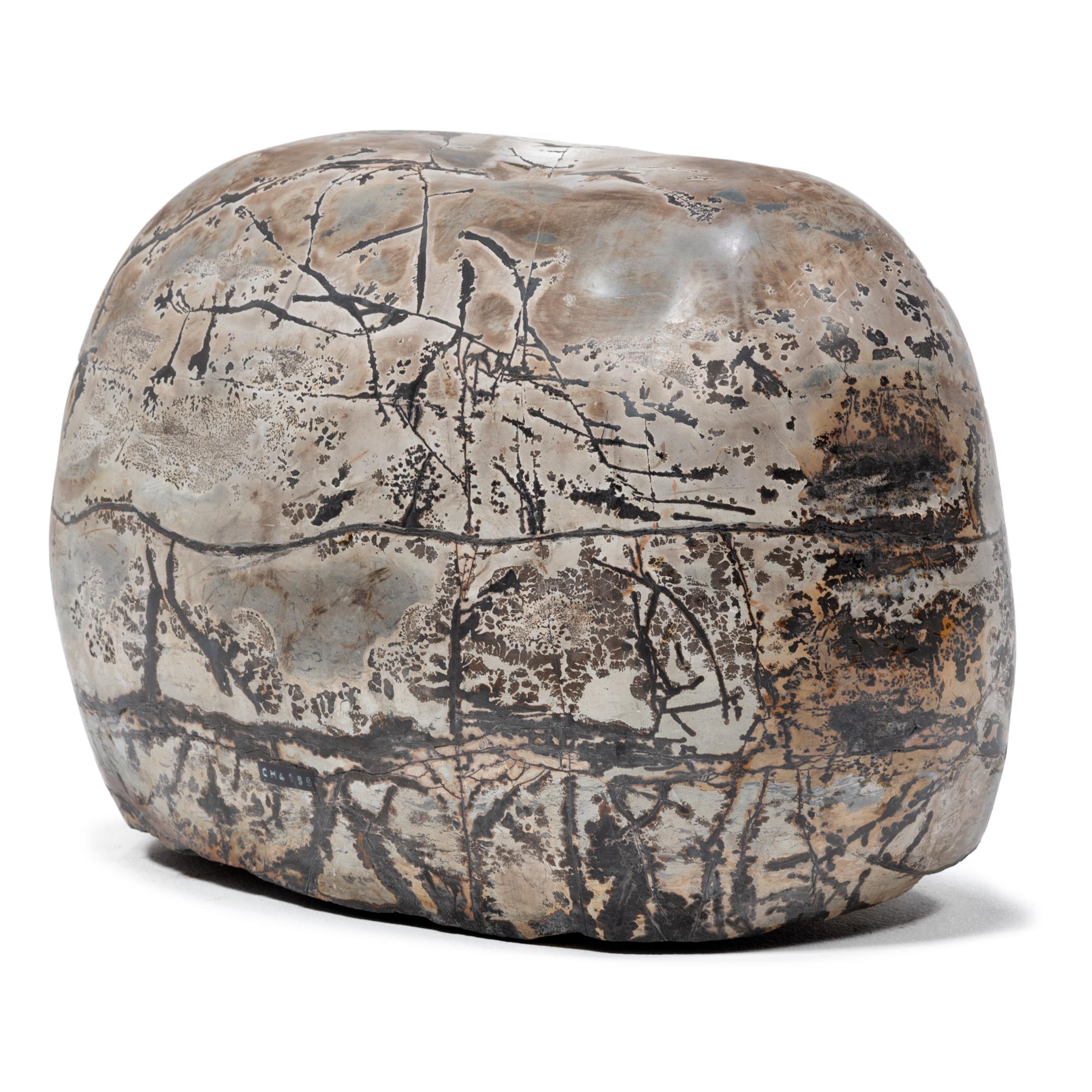 As if brushed with ink and inscribed with intricate calligraphy, this polished painting stone from Guangxi province is marked with swirling patterns of dark and light. To follow the stone's marbled coloring and natural veining can be deeply