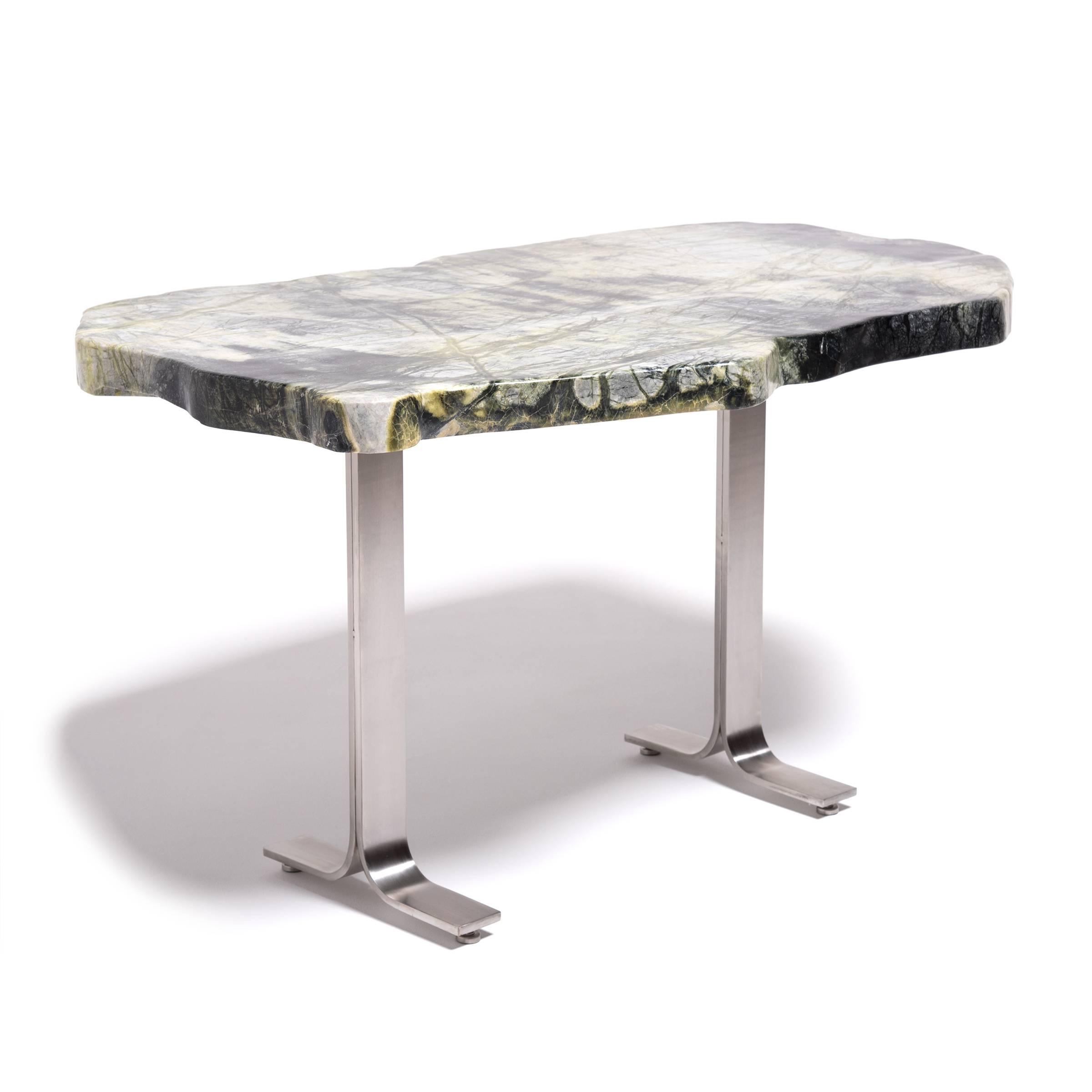 Prized by ancient scholars, meditation stones inspired the mind while they composed poetry, painted landscapes, or brushed calligraphy. The irregular shaped greenery stone specimen that tops this table is a mix of jadeite, moss agate, serpentine,