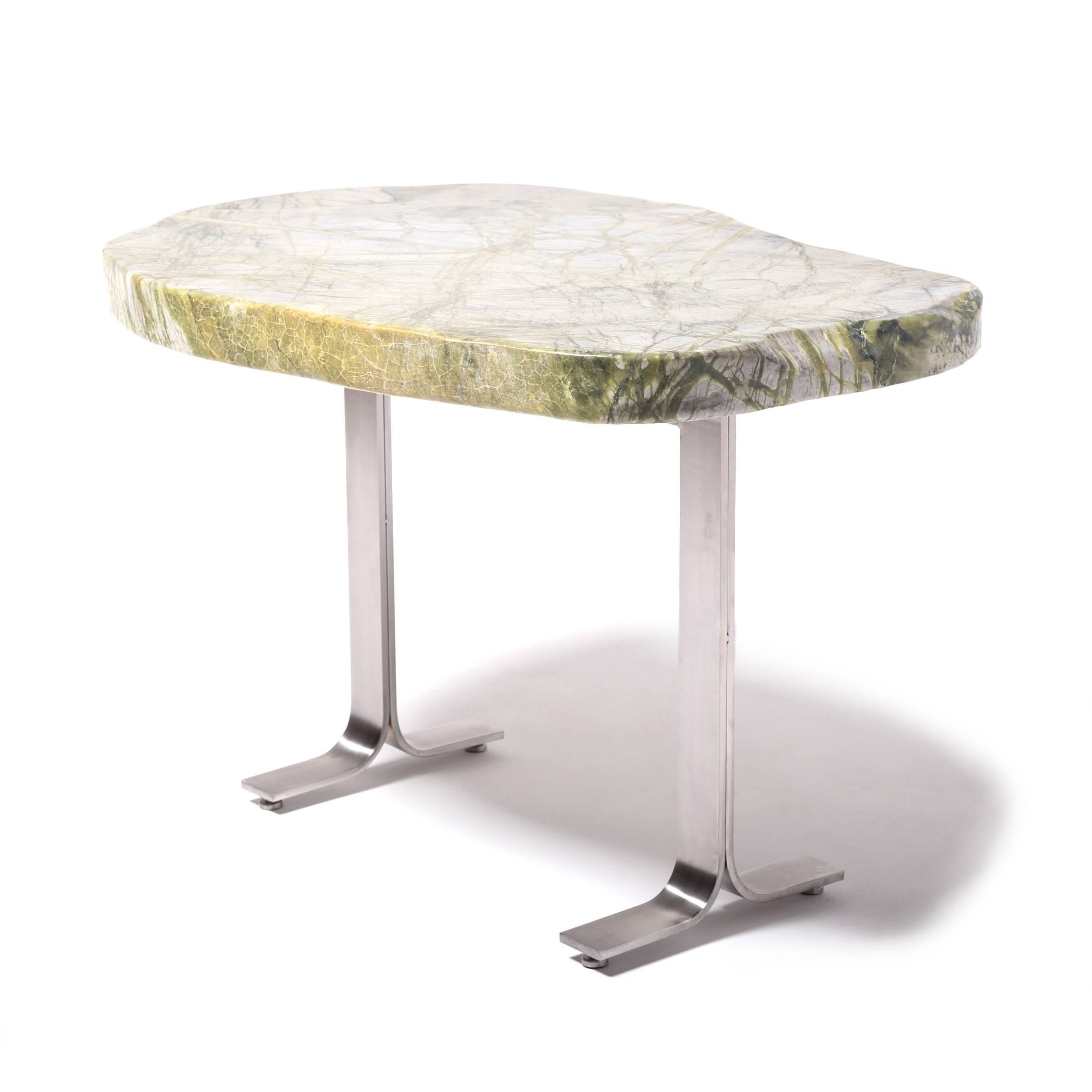 Prized by ancient scholars, meditation stones invigorated the imaginations of poets, painters, and calligraphers. The abstract shape and veining of the greenery stone that tops this table is a unique composition of jadeite, moss agate, serpentine,