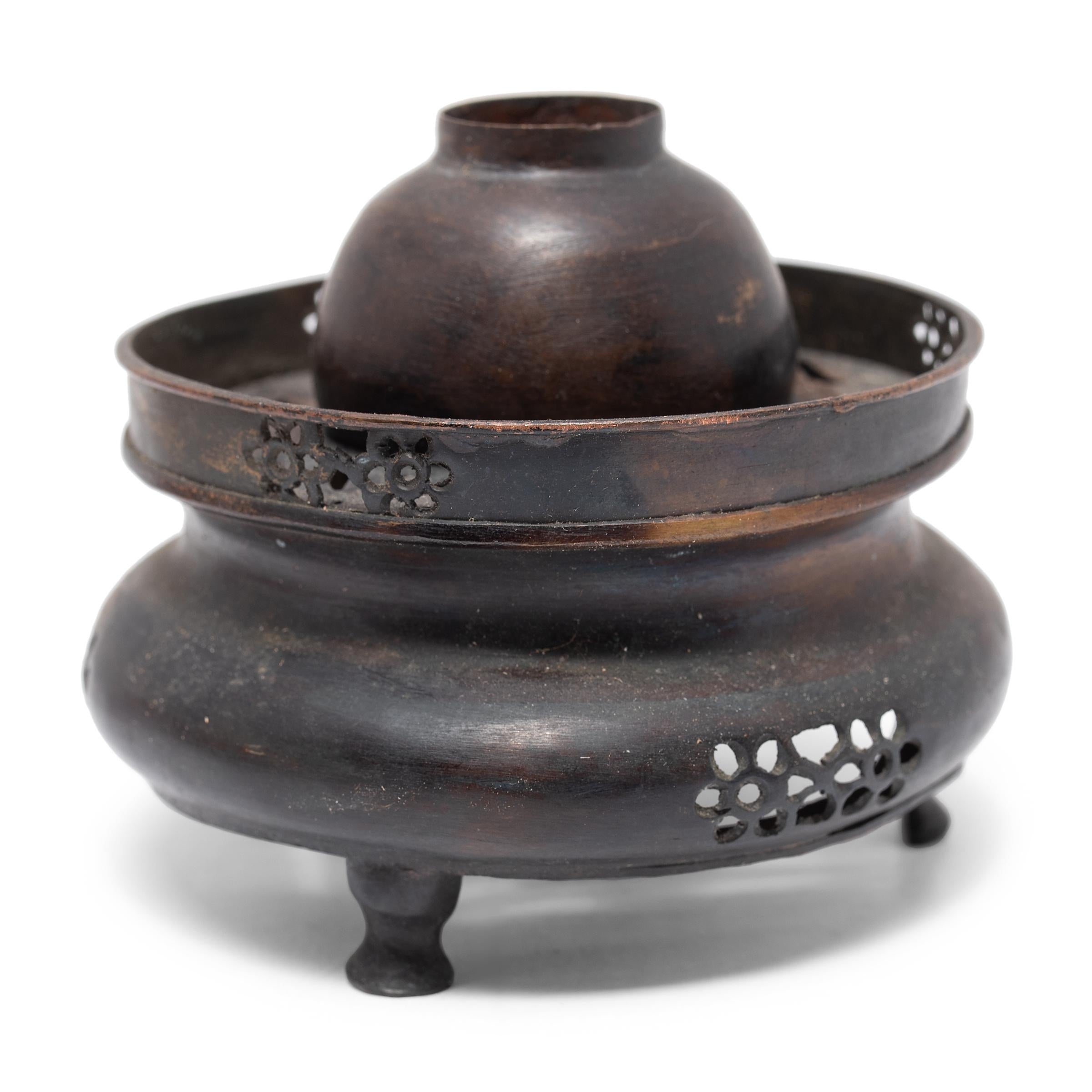 By the 18th century, opium use had become as central to Chinese social life as taking tea or smoking tobacco, fostering a subculture rich with its own customs, traditions, and exquisitely crafted accoutrements. This metal tripod vessel is the base
