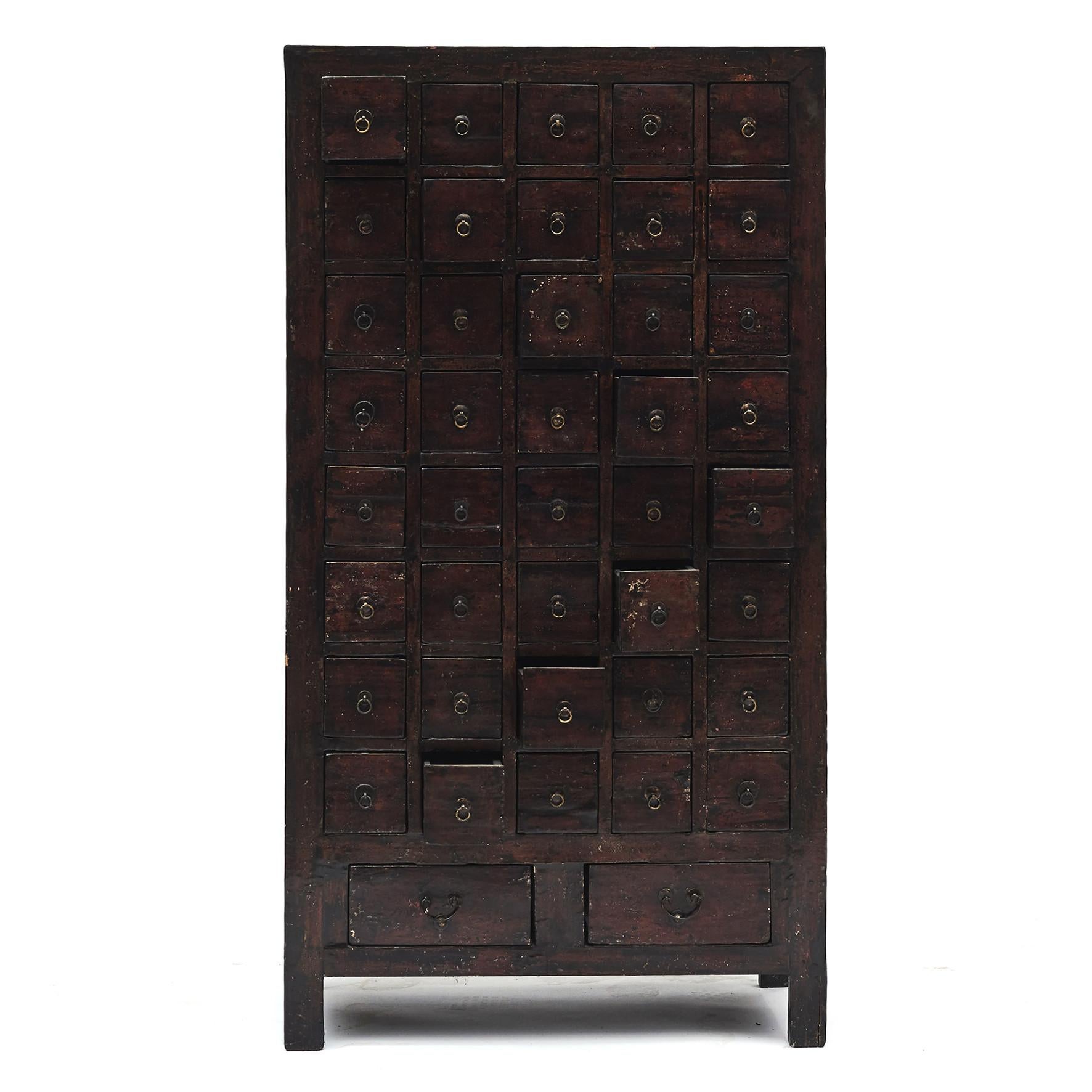 Chinese apothecary / pharmacy medicine chest with 42 drawers.
Original dark reddish brown lacquer with a beautiful natural age-related patina.
From Shanxi Province, mid-19th century.
Linden wood.