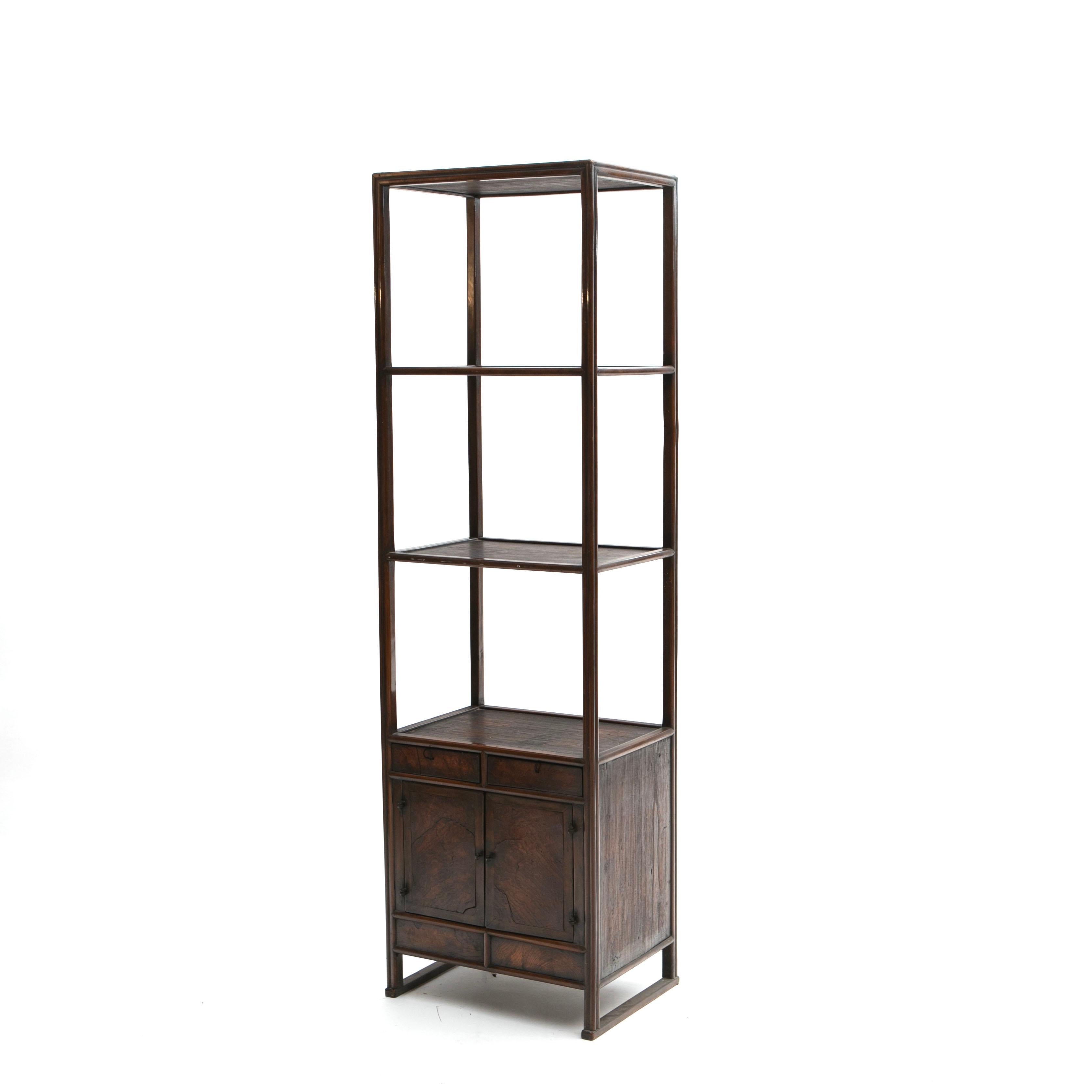 Chinese mid 19th century Ming style etagere with a frame crafted in walnut and burl elm wood fronts on drawers and doors.
Featuring three tiers of shelving over two drawers and lower cupboard for storage.
Jiangsu province, circa 1840-1860

High