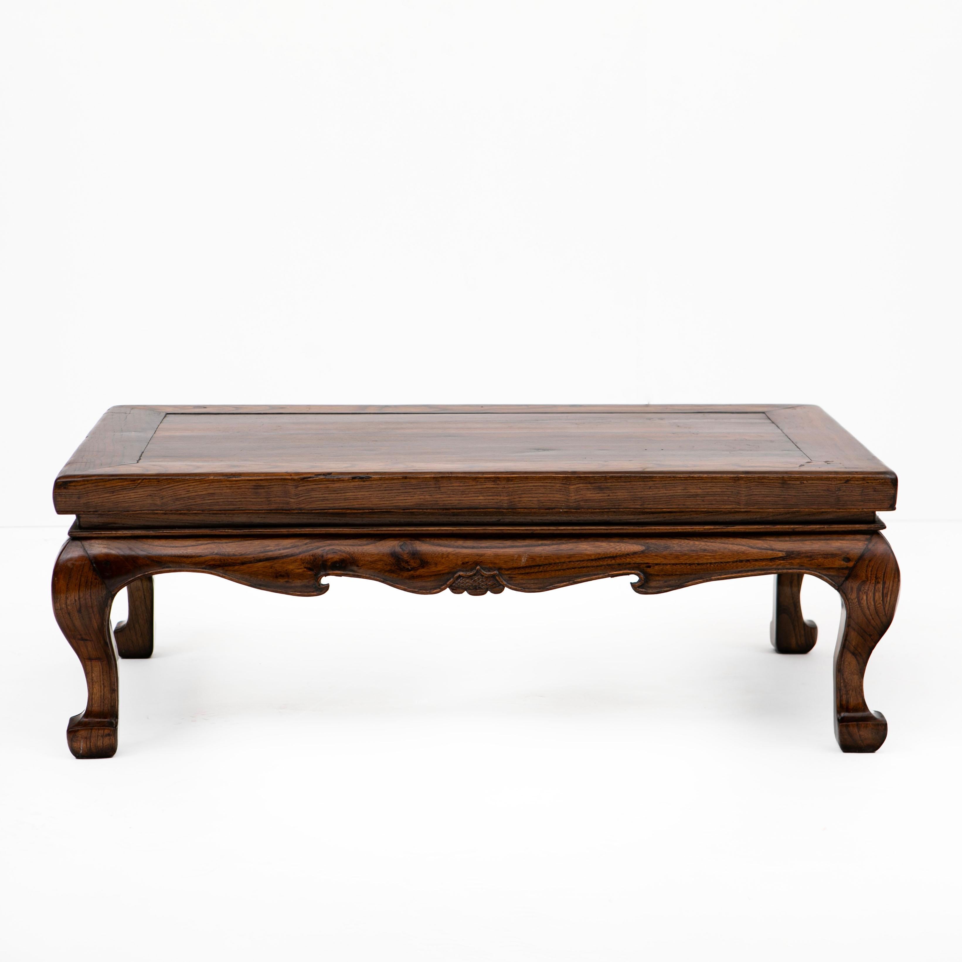 A Chinese kang table from China mid-19th century.
This low table is crafted in lacquered elm wood. It features a rectangular framed top and solid floating panel.
In original condition with a beautiful natural age-related patina highlighted with a
