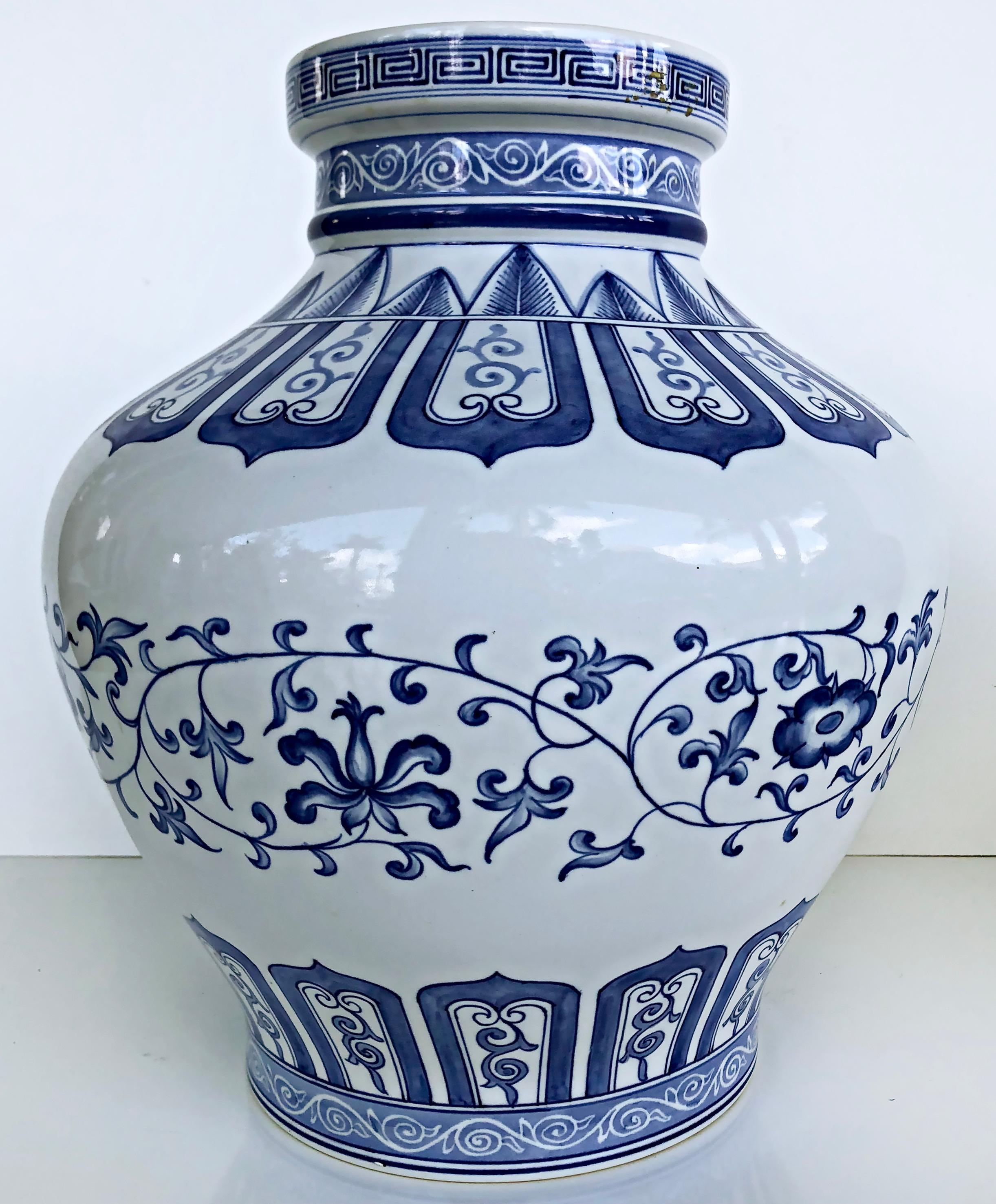 Chinese Mid 20th Century Blue and White Porcelain Vases, Pair

Offered for sale is an elegant pair of Chinese Mid 20th-Century blue and white porcelain vases with delicately painted floral and patterned motifs. The vases are signed on the bases as