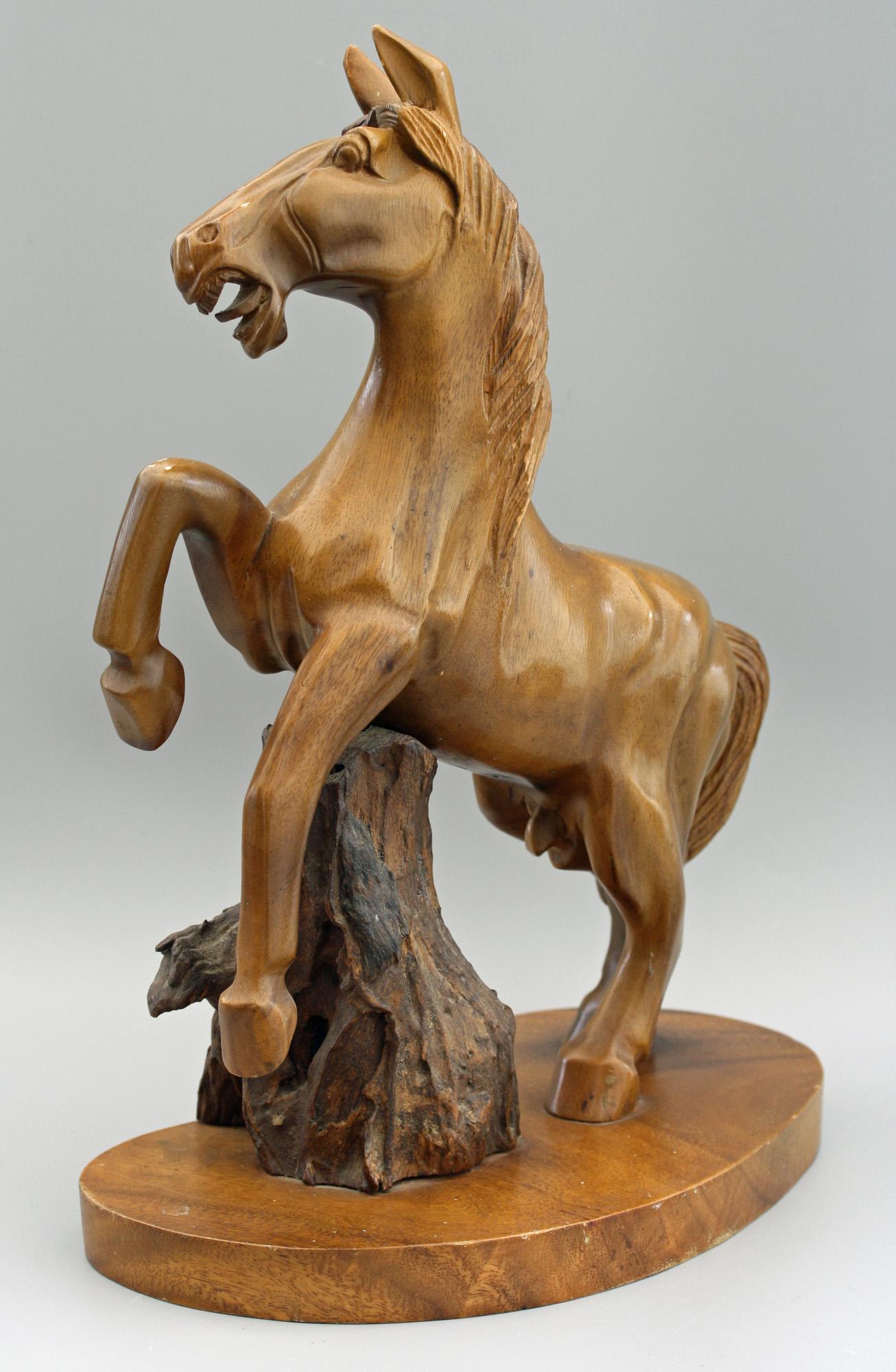 A vintage Chinese carved wooden figure of a rearing horse believed to date between 1950 and 1970. The horse originates from a family who were based in China and returned to England in the late 1970s and was acquired while living in China. The horse
