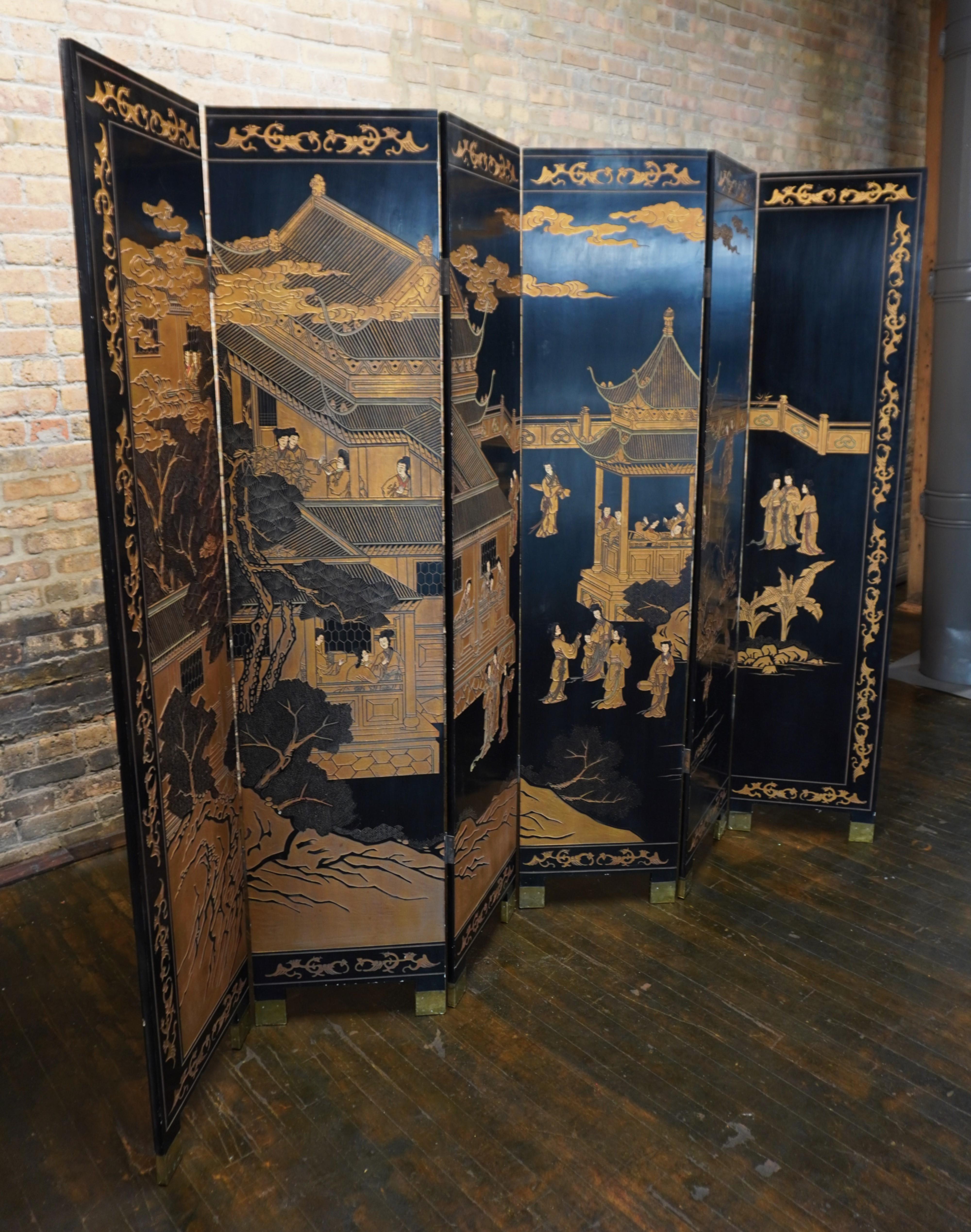 A large 6 panel Chinese Coromandel folding screen.  This screen has a background that is primarily black lacquer.  It features several building, clouds, figures, trees and birds.  

Most of the decoration on the front of the screen is gilded.  There
