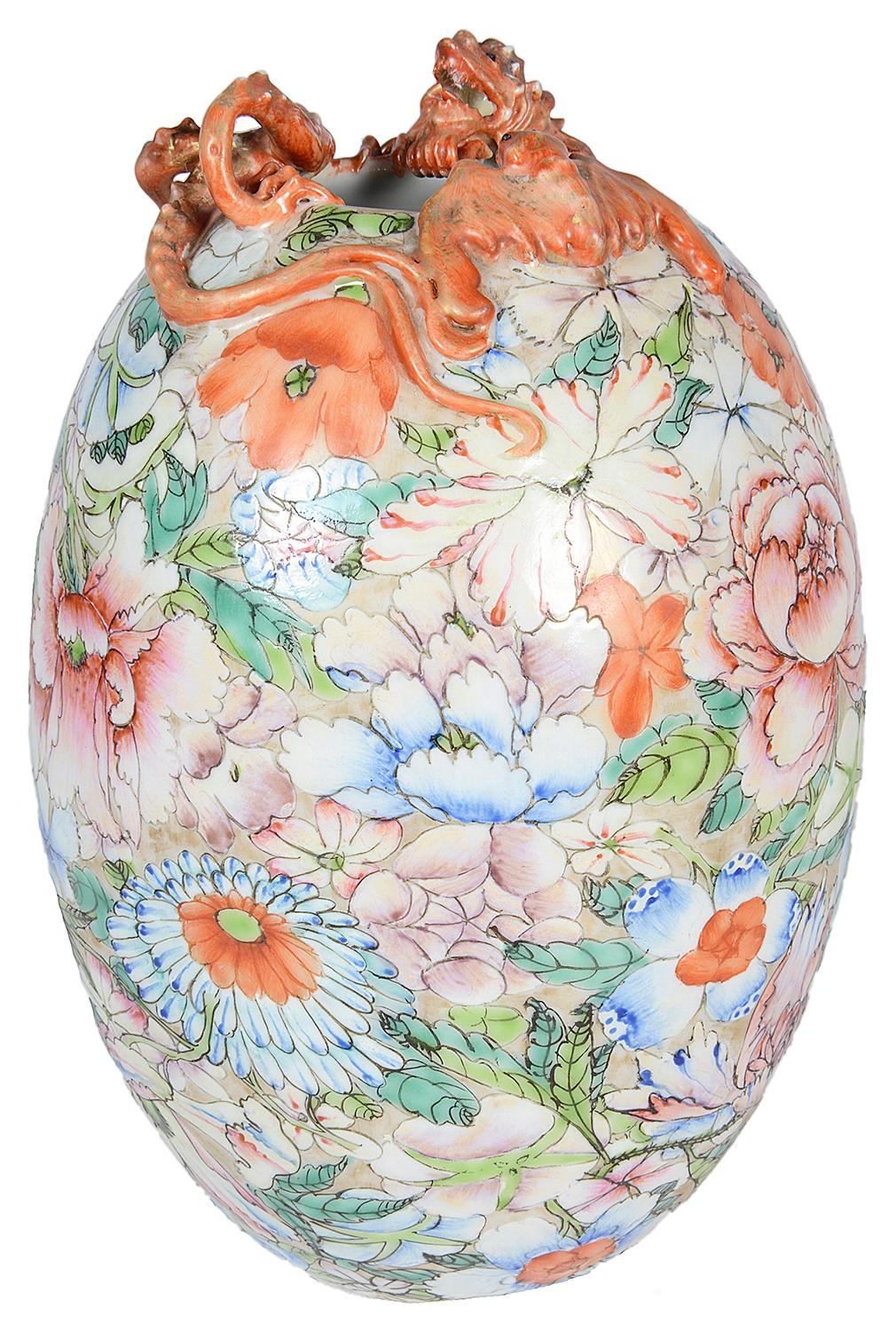 A good quality Chinese Millie Fleur porcelain vase, having a mythical iron red dragon around the top, wonderful exotic floral decoration to the body and a six character mark to the base.