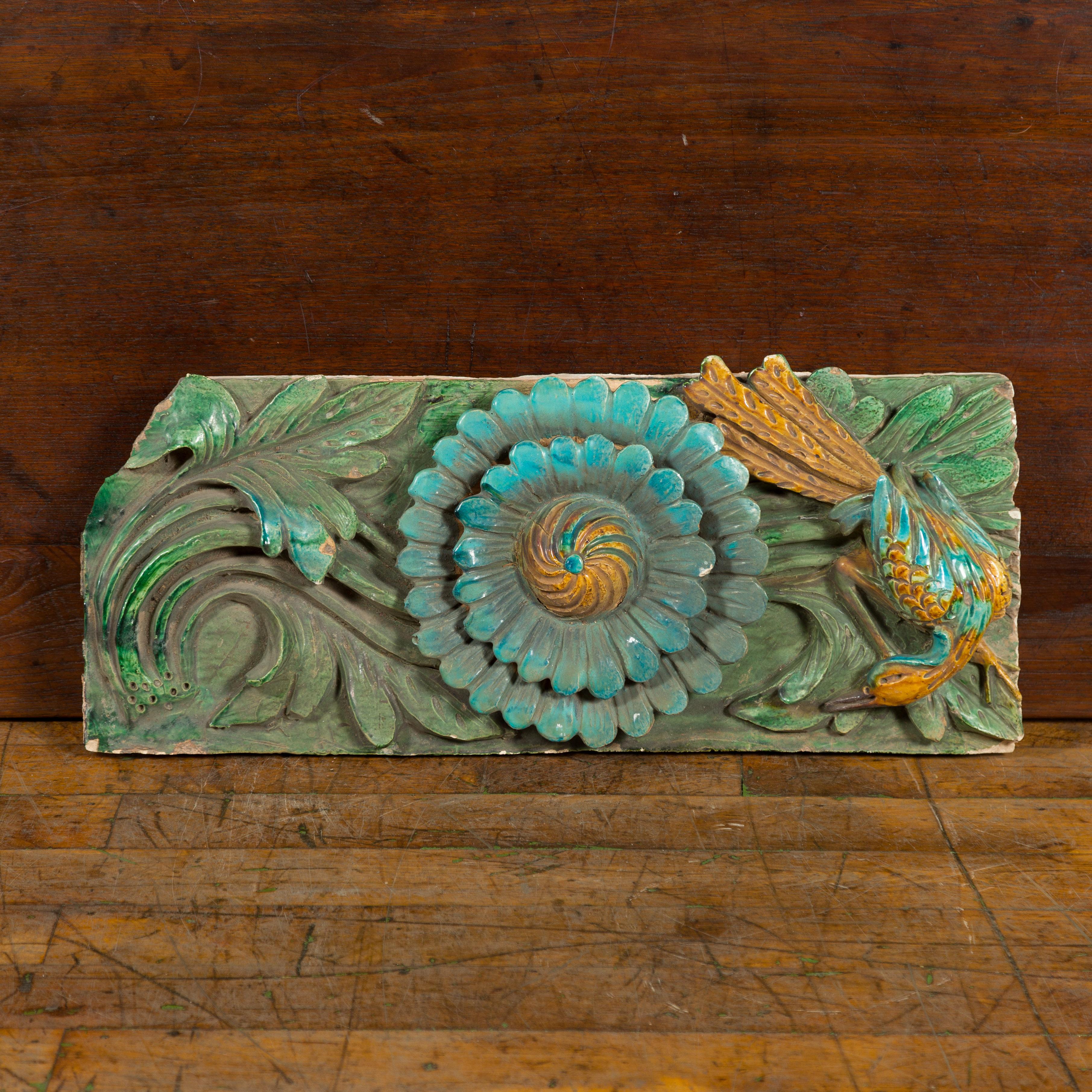 A Chinese Ming Dynasty period temple roof tile from the 17th century, with turquoise finish, bird and flower. Created in China during the Ming Dynasty (1368-1644), this ancient temple roof tile was made from molded terracotta and painted. Showcasing