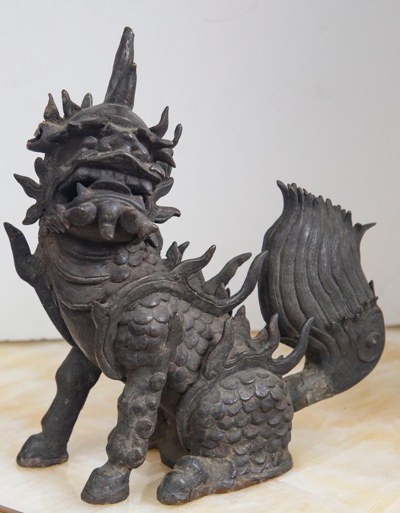 The mythological kylin in a setting position. Well crafted of bronze with many points, a large tail and scales over body.