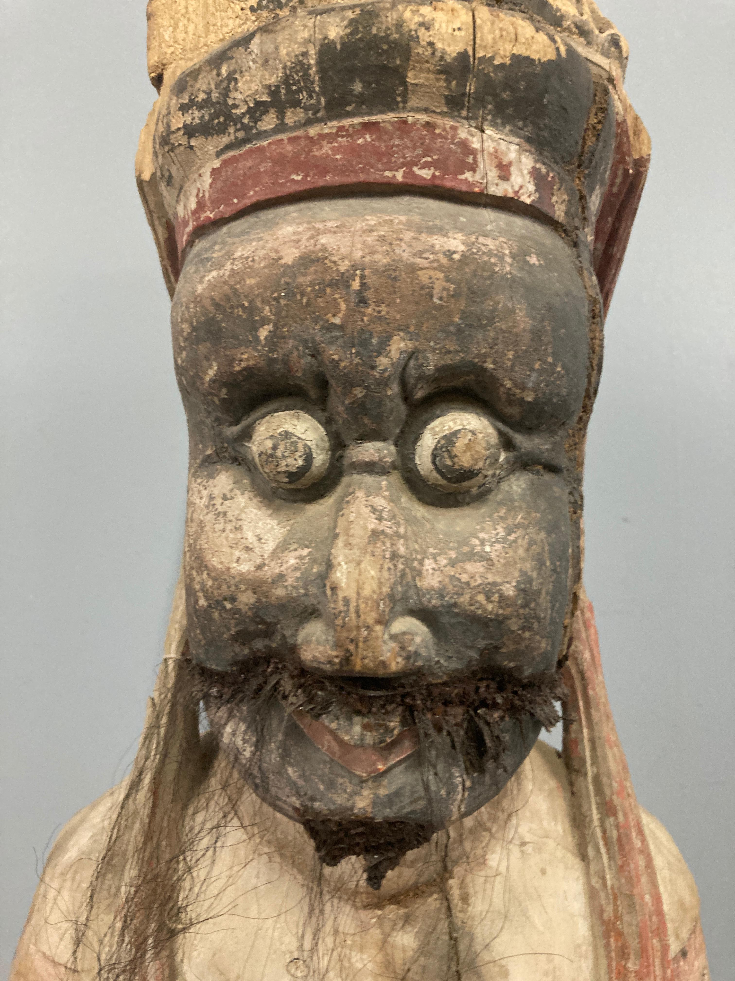 A carved wood Budda from the Shanxi region, made during the Ming Dynasty. The carved figure has an ancient polychrome finish.