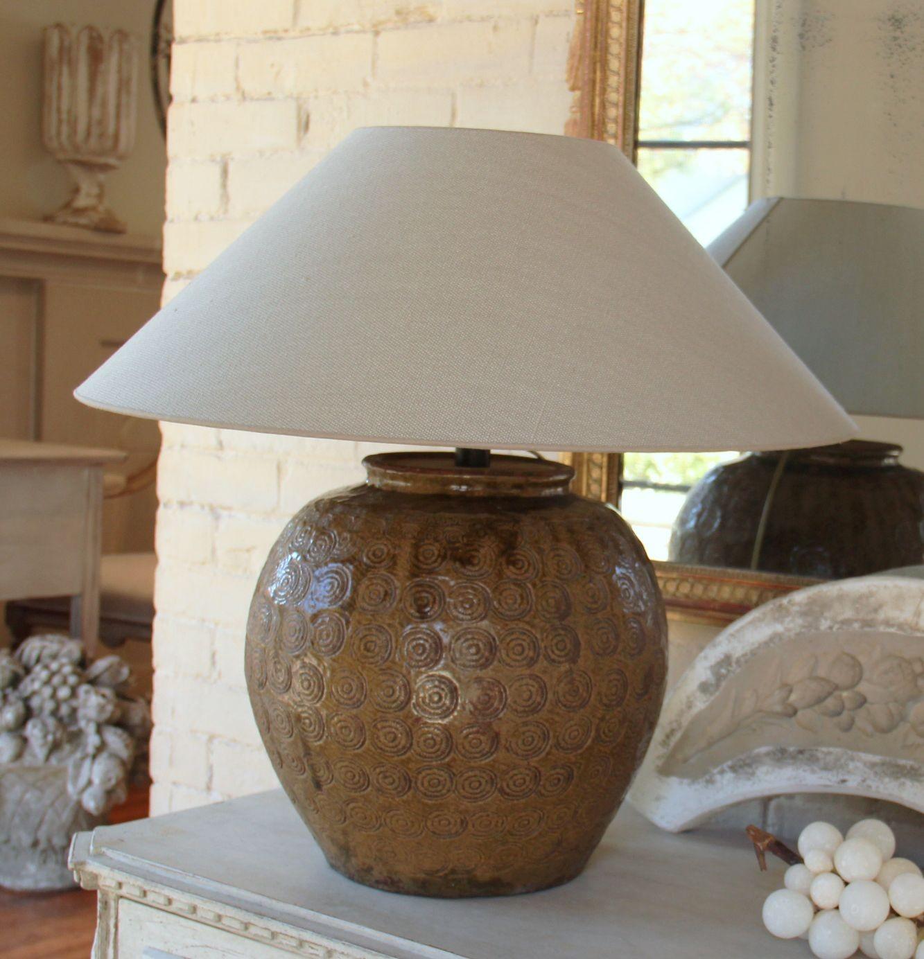 A Chinese Ming Dynasty ceramic vase that has been mounted as a table lamp. The vase has a beautiful amber glaze and coin shell pattern. The greige colored lampshade is handmade in Belgium of fine linen and has a high-quality gold foil inner lining.