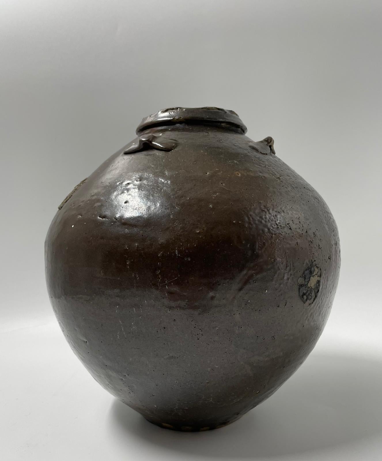  Chinese Ming Dynasty 1368 - 1644 Martaban Jar . Dates to the early Ming period .
High neck and wide shoulders , brown slip glaze , unglazed base , loop-handles. rolled lipped rim typical of Chinese ware .
Please see book 