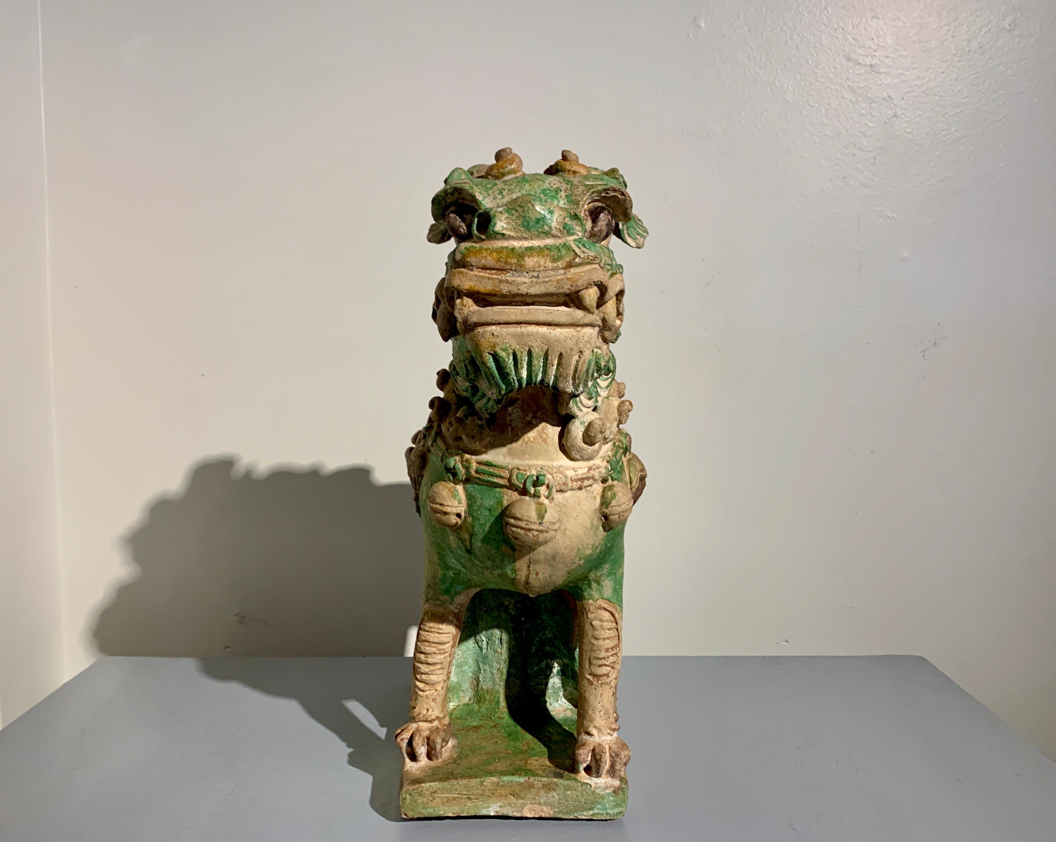 Chinese Ming Dynasty Sancai Glazed Pottery Guardian Lion, late 16th Century In Fair Condition For Sale In Austin, TX