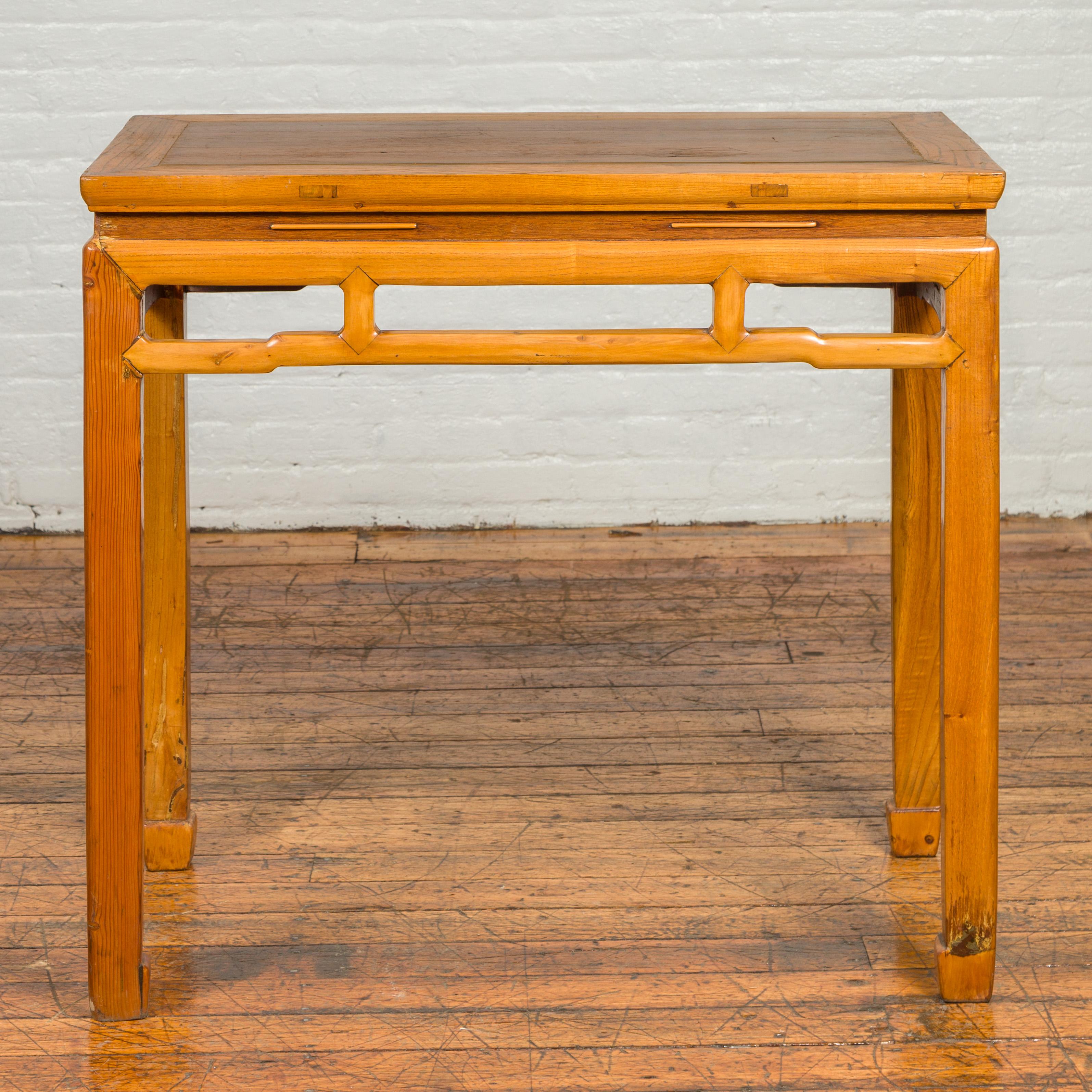 A Ming Dynasty style vintage waisted altar console table from the mid-20th century, with horsehoof legs and humpbacked stretcher. Delve into the elegance of classical Chinese design with this Ming Dynasty style vintage waisted altar console table