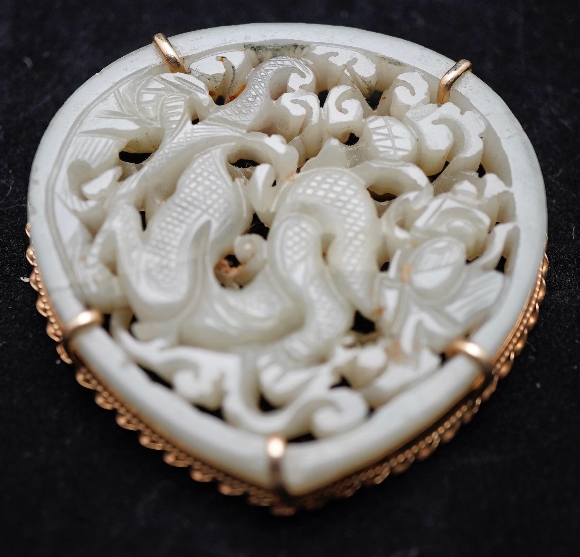 Chinese Ming period dragon carving mounted as pendant in yellow gold. The metal mounting is marked 14K. Total weight 44g.