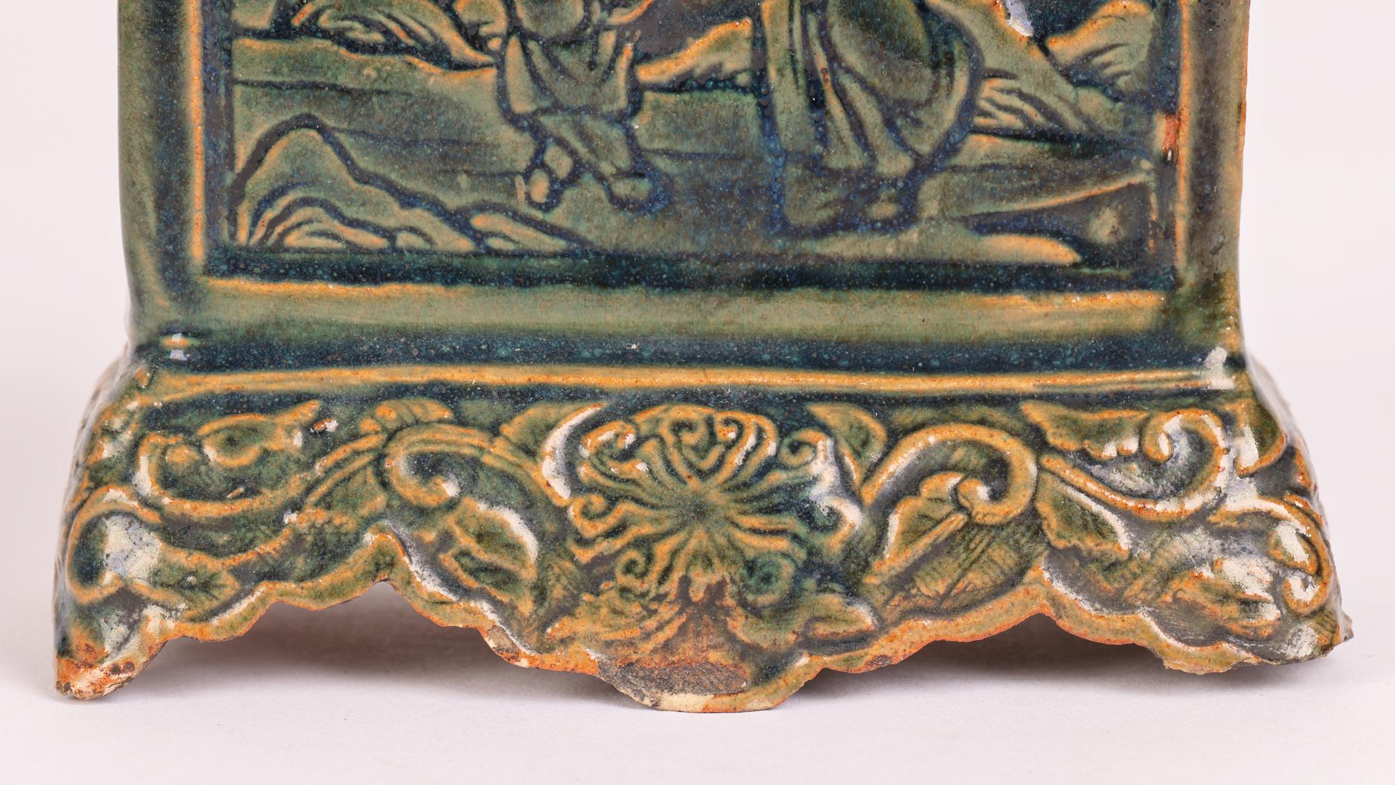 A good Chinese biscuit pottery glazed incense holder with relief molded figural scenes dating from the late Ming period or later. The incense holder stands raised on a footed pedestal base decorated with scrolling floral designs in low relief. With