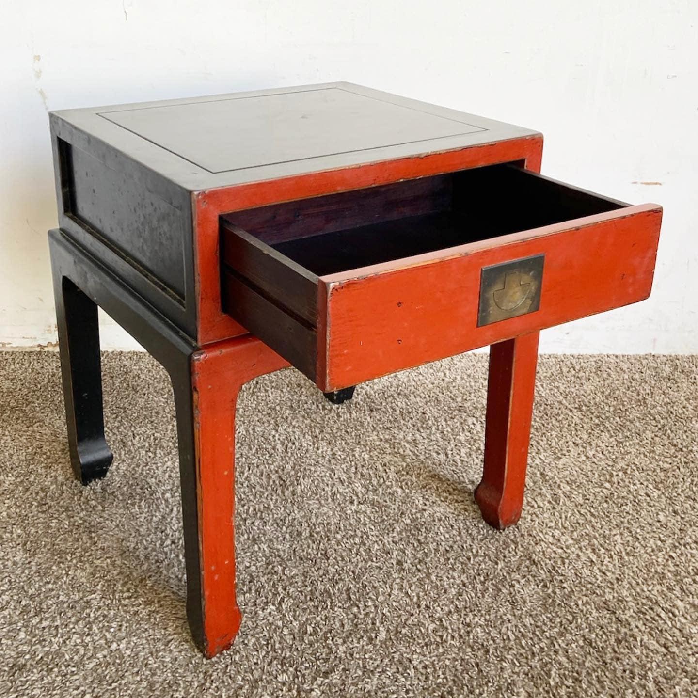 Experience the elegance of the East with this Chinese Ming Style Red Nightstand. Boasting a striking red finish, its traditional design and intricate details pay homage to historical craftsmanship. While rooted in history, it offers modern