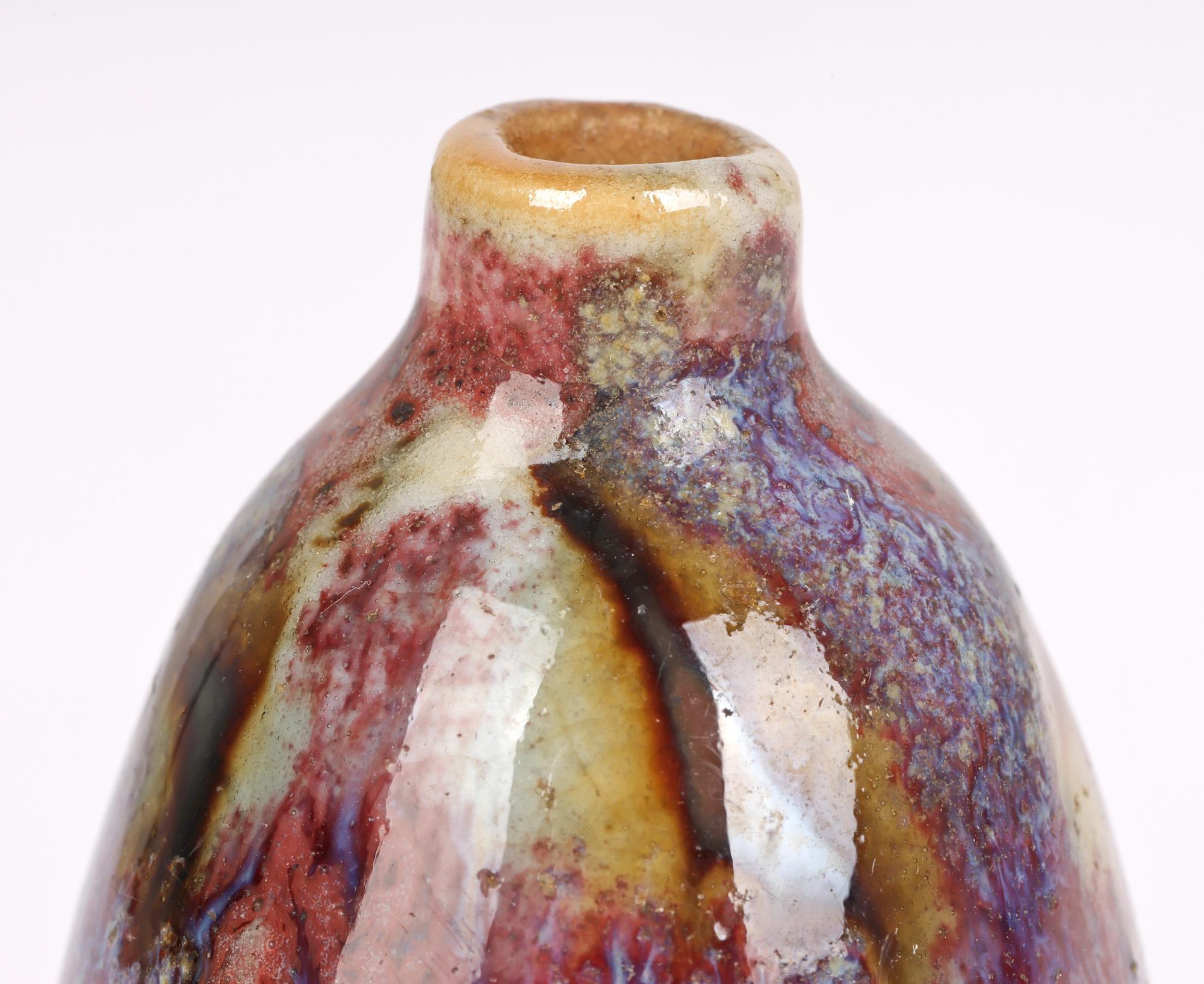 A fine quality Chinese miniature vase decorated in mottled glazes dating from the latter 19th or 20th century. The stoneware vase stands raised on a narrow round foot and is of tall bulbous form with narrow and short raised cylindrical neck and