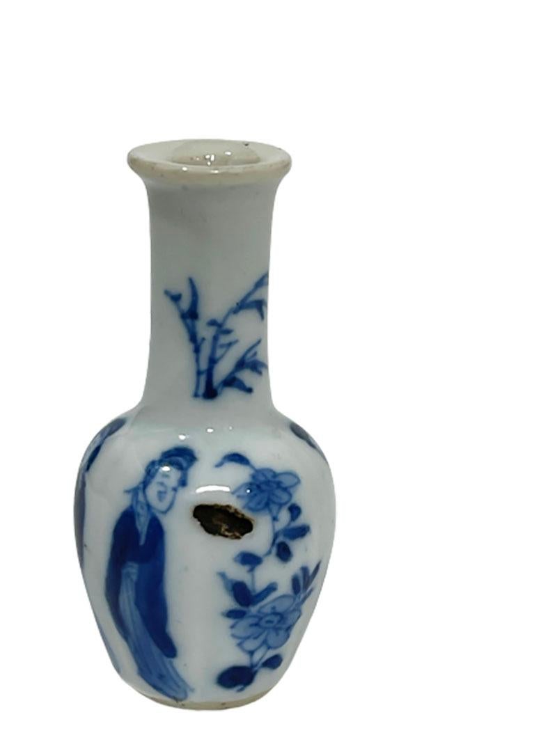 Chinese Porcelain Dollhouse miniature blue and white Kangxi vase
Kangxi (1662-1722), ca 1720

With a scene of floral decor and long Eliza
The porcelain vase has a firing error, happened during the firing (baking) process

The measurements are 5,8 cm