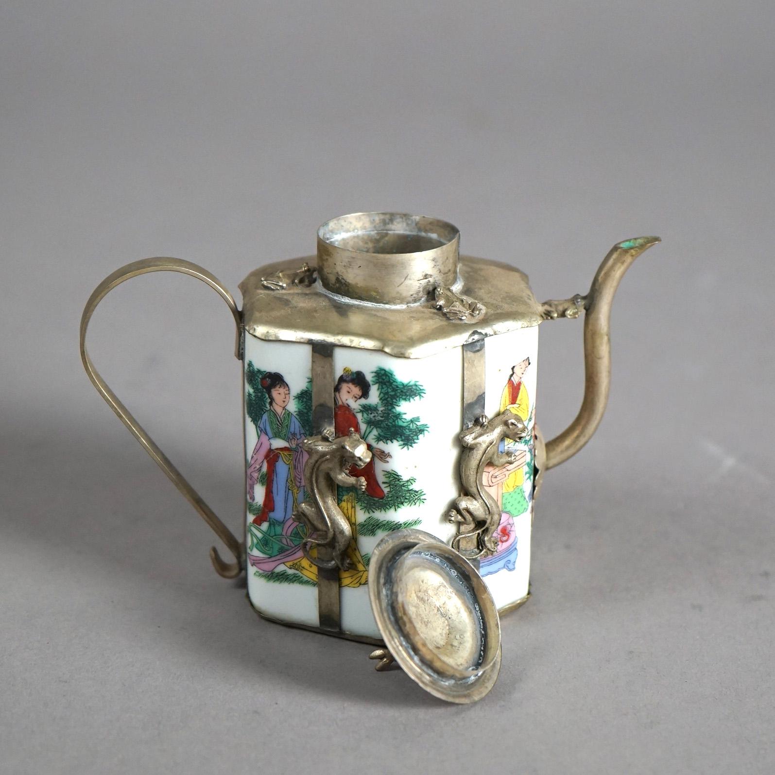 A Chinese miniature teapot offers porcelain vessel with hand painted figures, housed in silver overlay having figures, signed as photographed, 20th century

Measures- 4.25''H x 5''W x 3''D