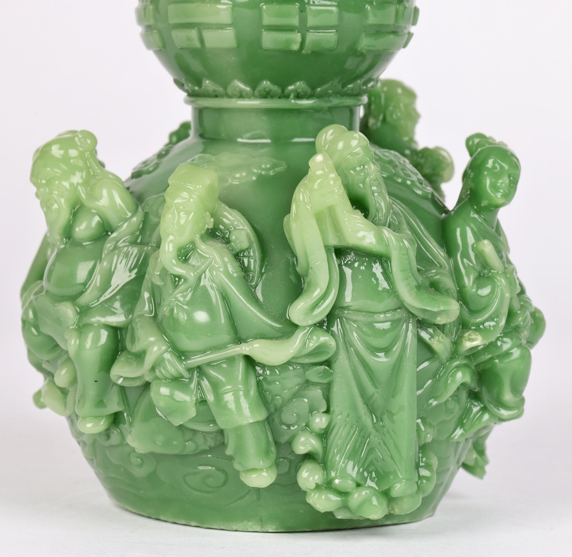 A good quality Chinese vintage double gourd scroll weight molded with scholars, court ladies and a small boy dating from the 20th century. The weight is formed in a mottled green resin which simulates jade and is beautifully made with five scholar
