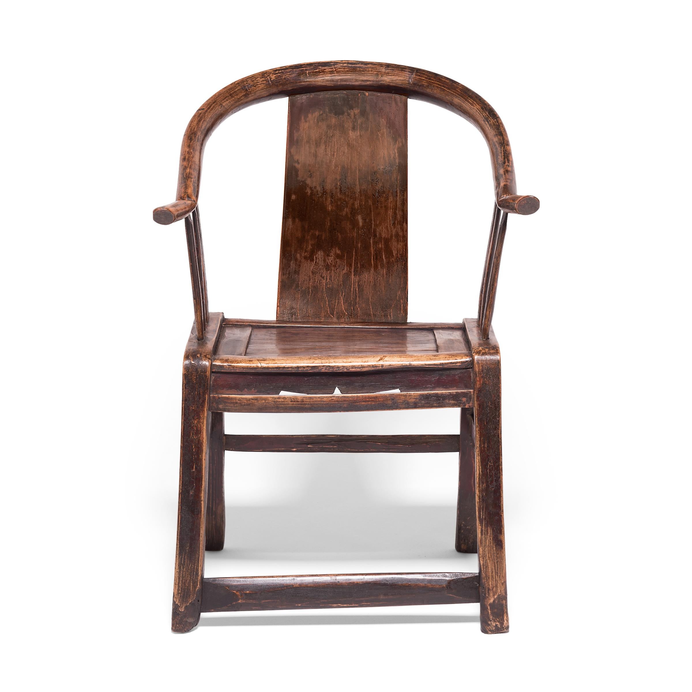 This 19th century moongazing chair from northern China was constructed by a Provincial carpenter who heated and bent willow wood into the rounded and upturned shape of the chair's arms. This simple, sculptural form hearkens back to Classic Chinese