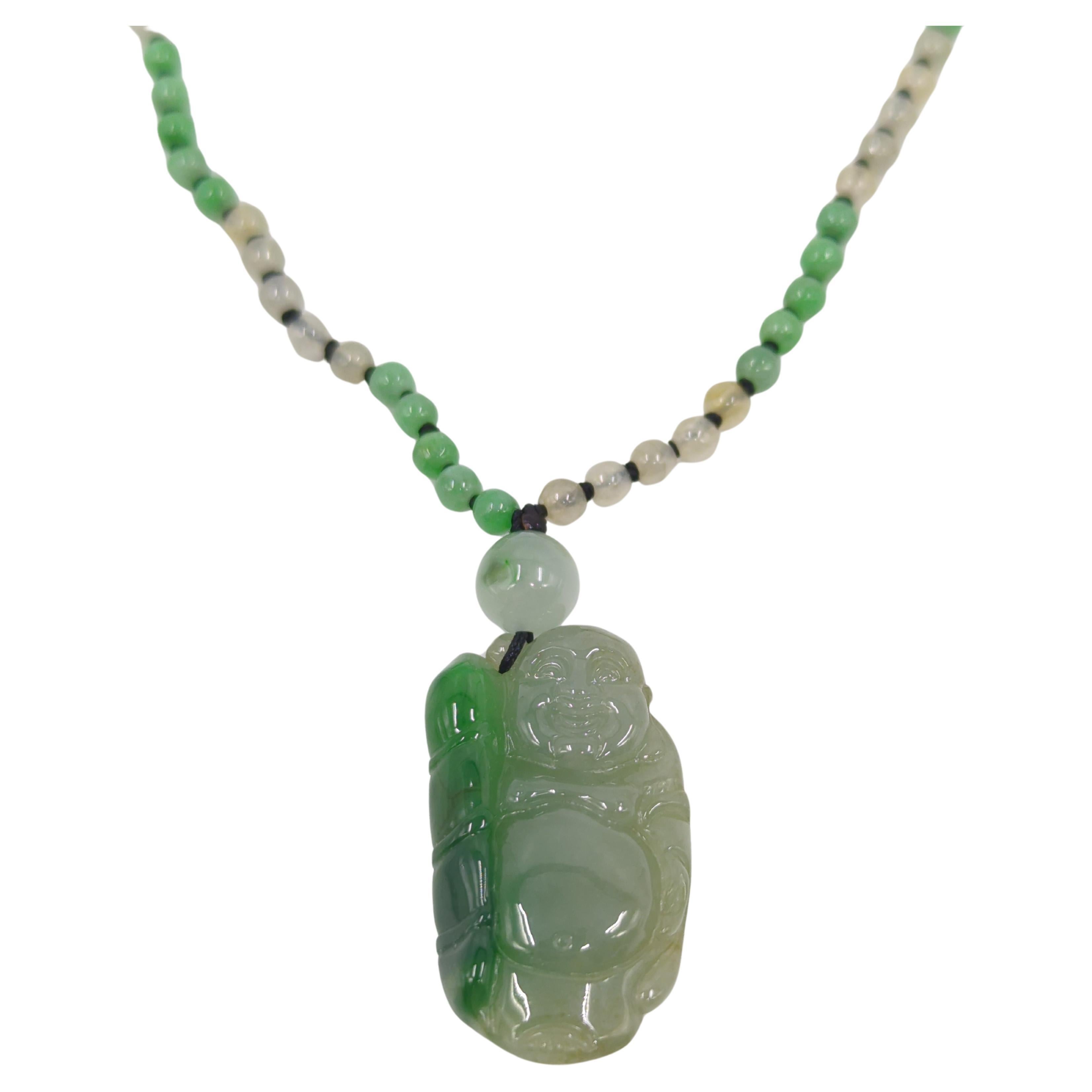 A fine Chinese laughing Buddha pendant in moss green and light celadon jadeite, on a matching light mint green and icy jadeite beaded necklace 21
