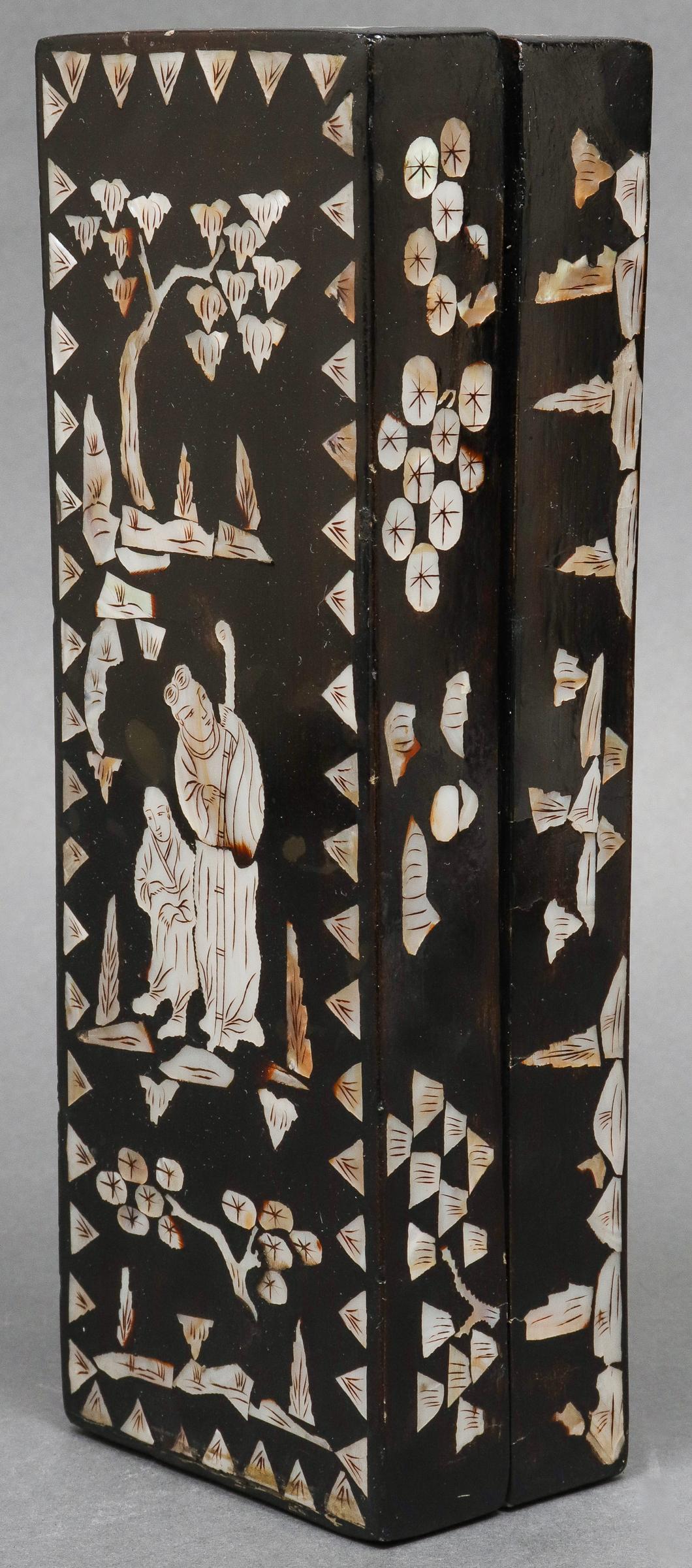 Chinese mother of pearl inlaid lacquered long rectangular box, the cover depicting two figures or immortals with all-over landscape decoration, circa late 19th-early 20th century. 2.5