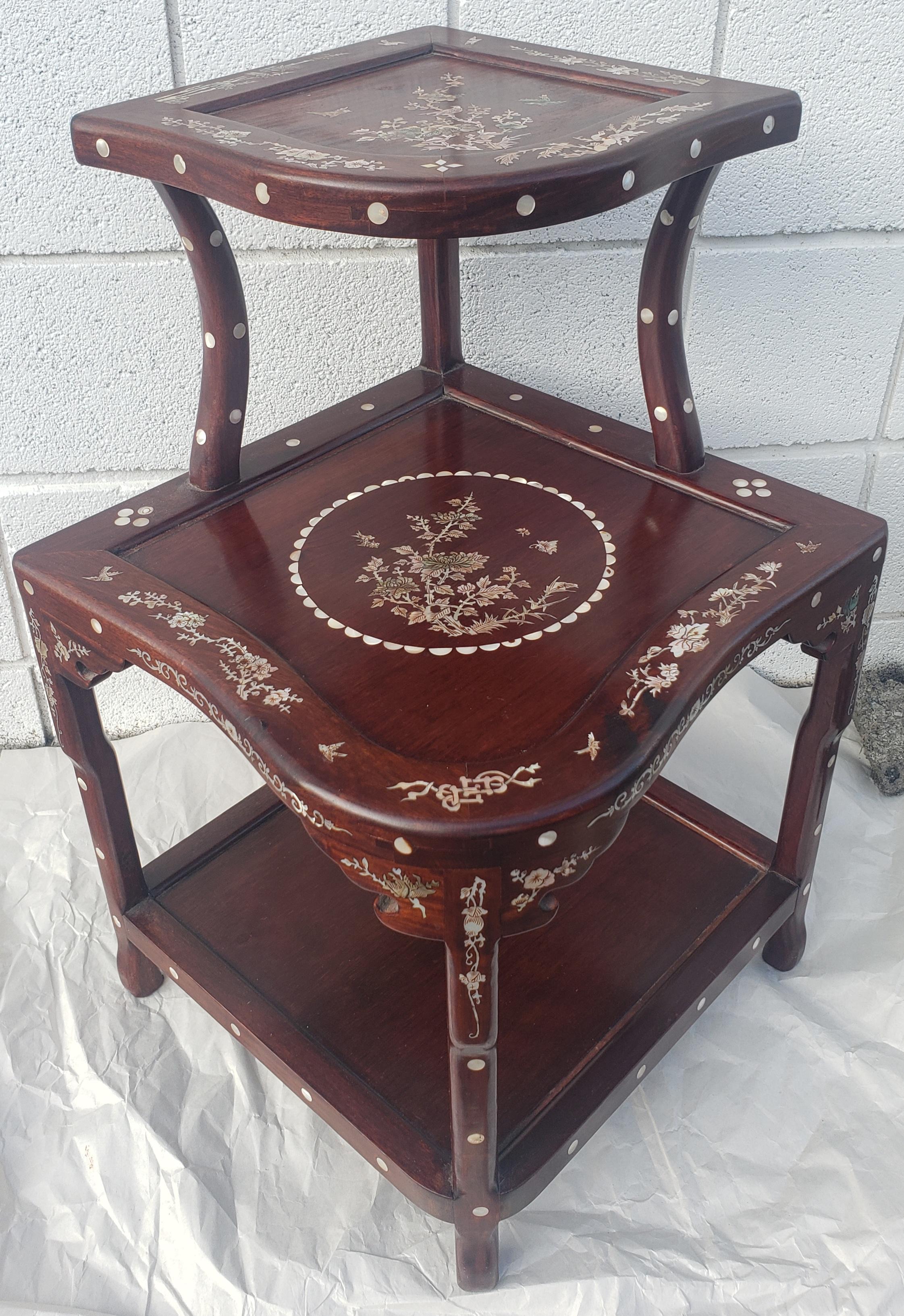 A Chinese Mother-of-Pearl Inlaid Rosewood three-tier Corner Table in great vintage condition. Measures 22.5