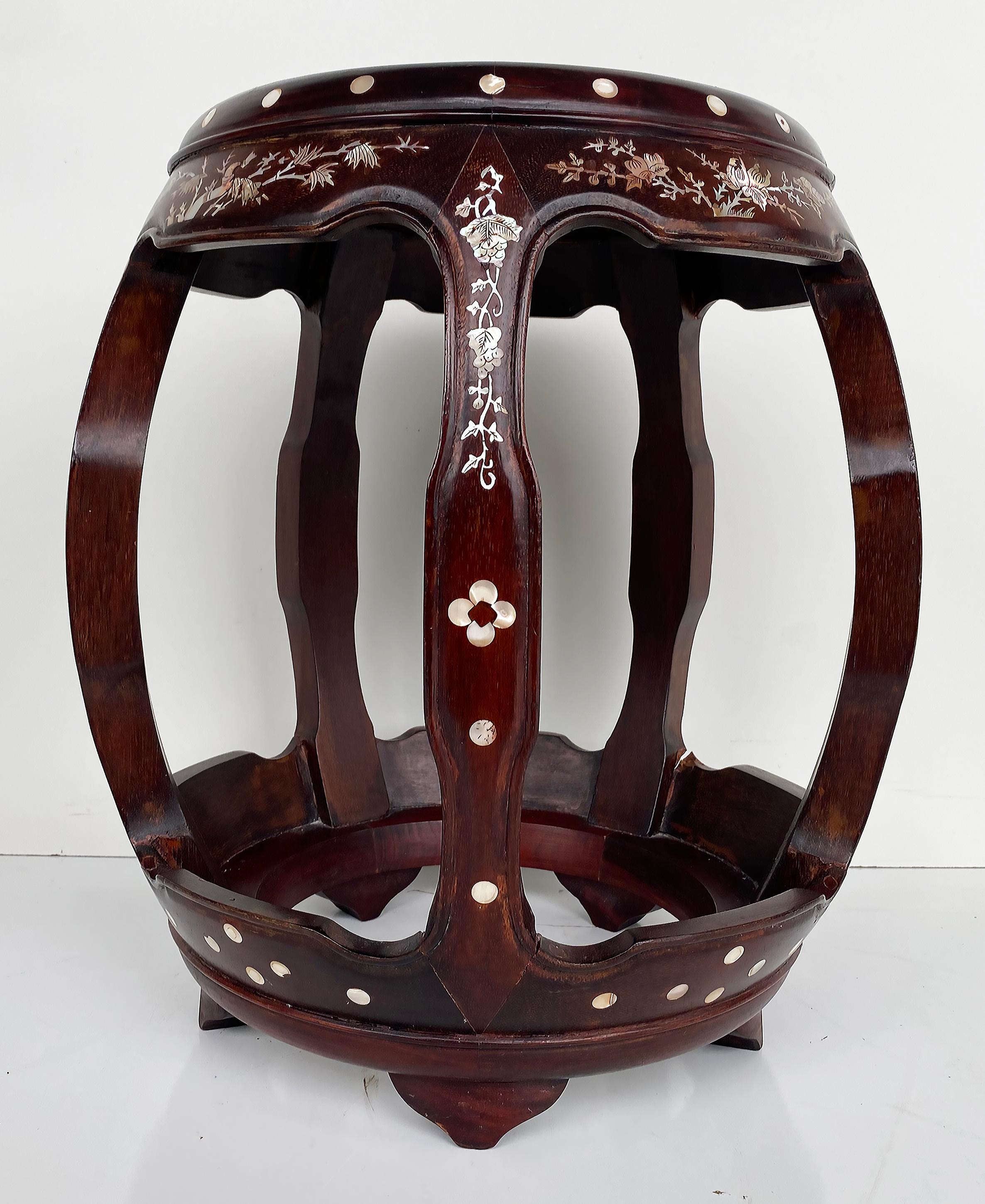 Chinese Mother of Pearl Inlaid Round Wood Drum Side Table

Offered for sale is a Chinese mother of pearl finely and intricately inlaid round wood drum table.  The matching corner chair which is shown in the last photo is offered in a separate