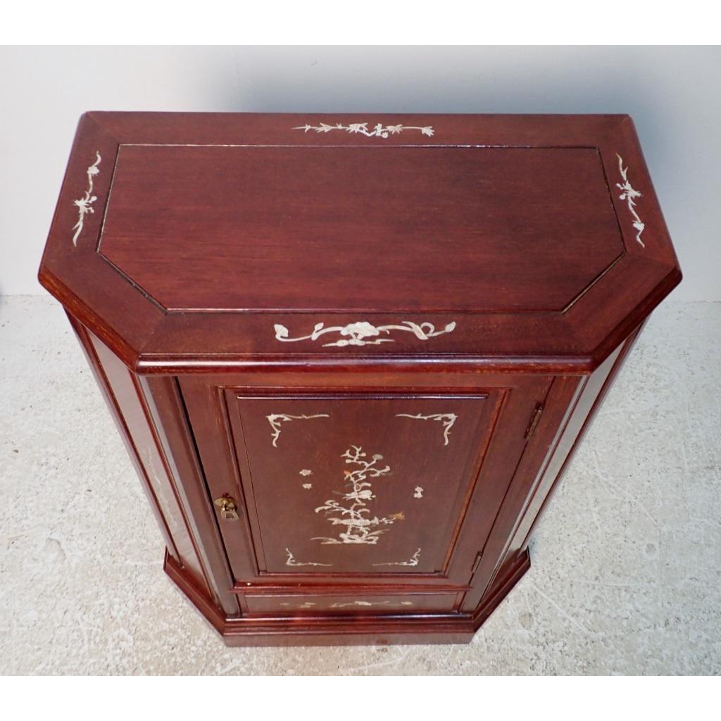 Chinese teak wood mother of pearl inlaid cabinet features floral and bird design.