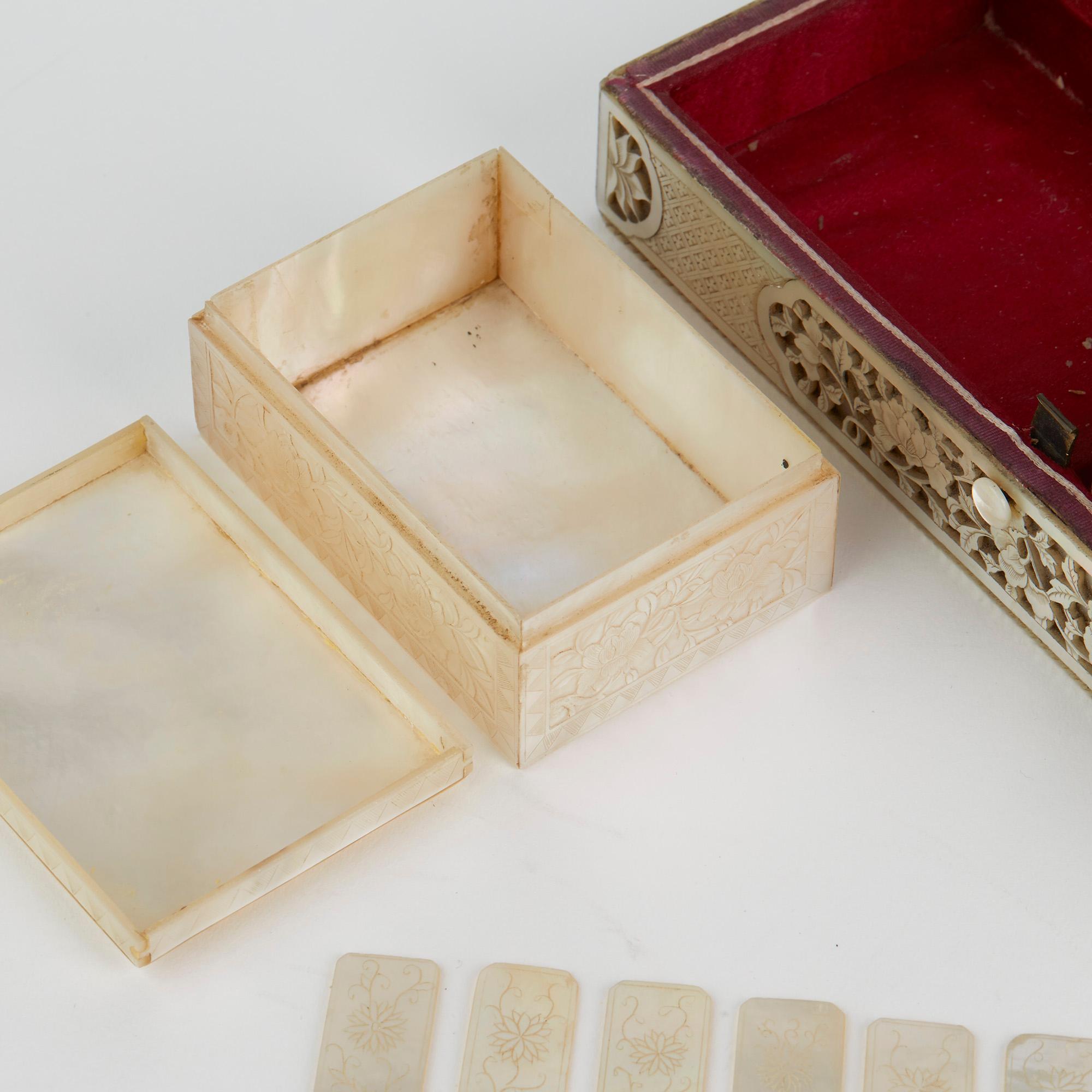 An exceptional and rare Chinese mother of pearl mounted games box with four matching interior boxes containing gaming counters and dating from the 18th century. The rectangular shaped box has a hinged cover, the wooden body mounted with deep carved