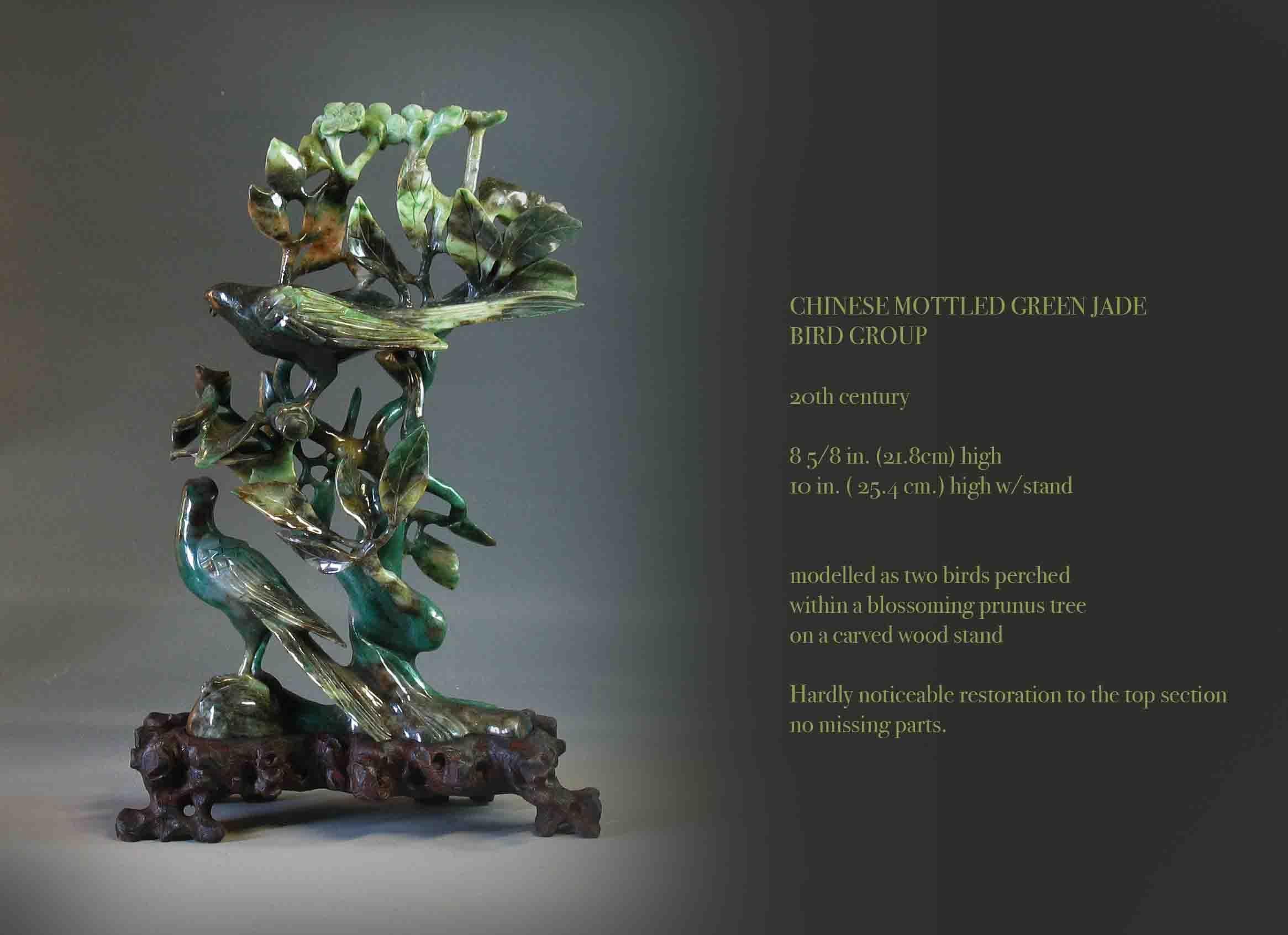 Chinese mottled green jade
Bird grouping

20th century.

Measures: 8 5/8 in. (21.8cm) high
10 in. ( 25.4 cm.) high w/stand.


Modelled as two birds perched 
within a blossoming prunus tree
on a carved wood stand.

Hardly noticeable