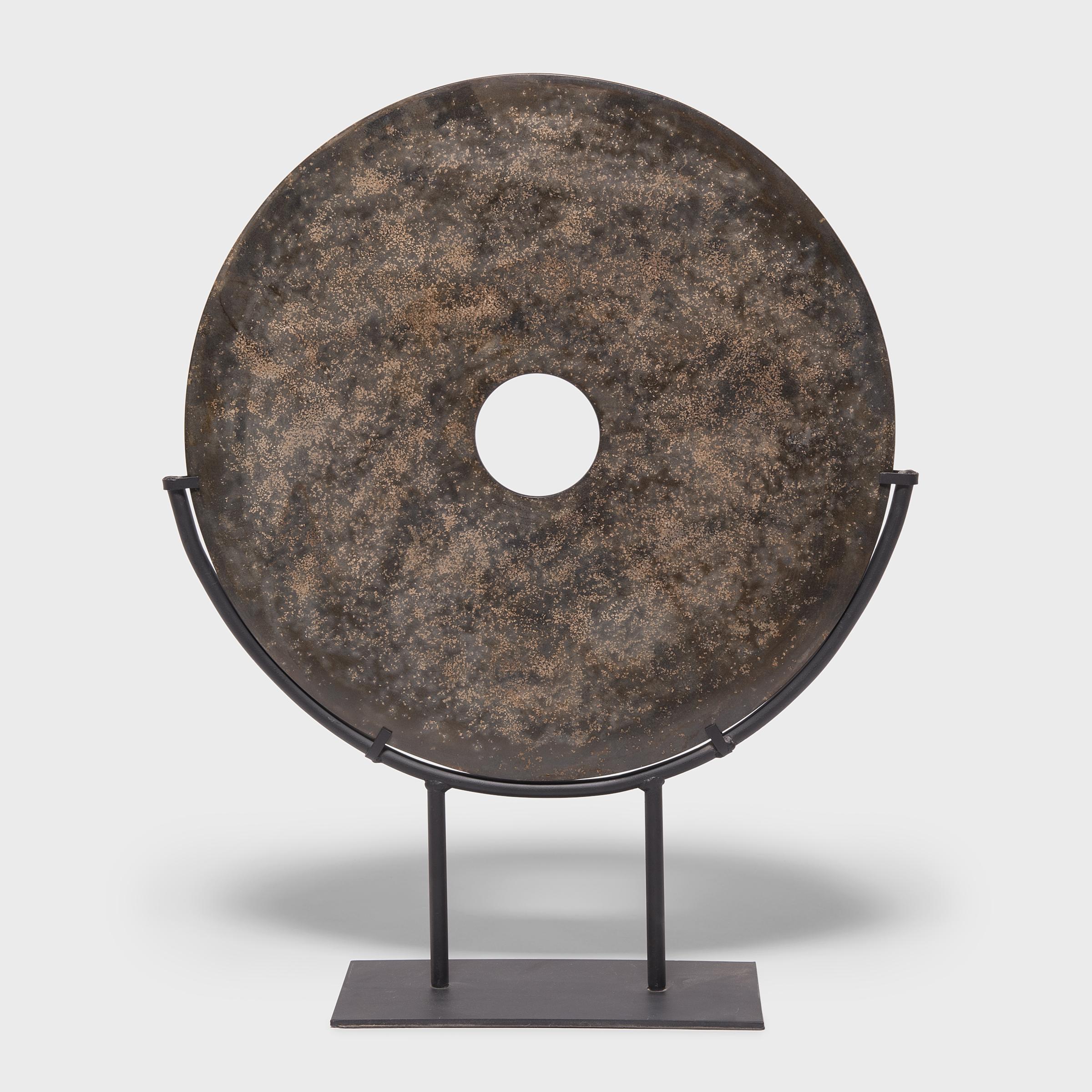Found in the tombs of ancient Chinese emperors and aristocrats, bi discs such as this have a mysterious and spiritual history, and their function and significance remain unknown. Shaping this hard stone takes considerable skill. An artisan patiently