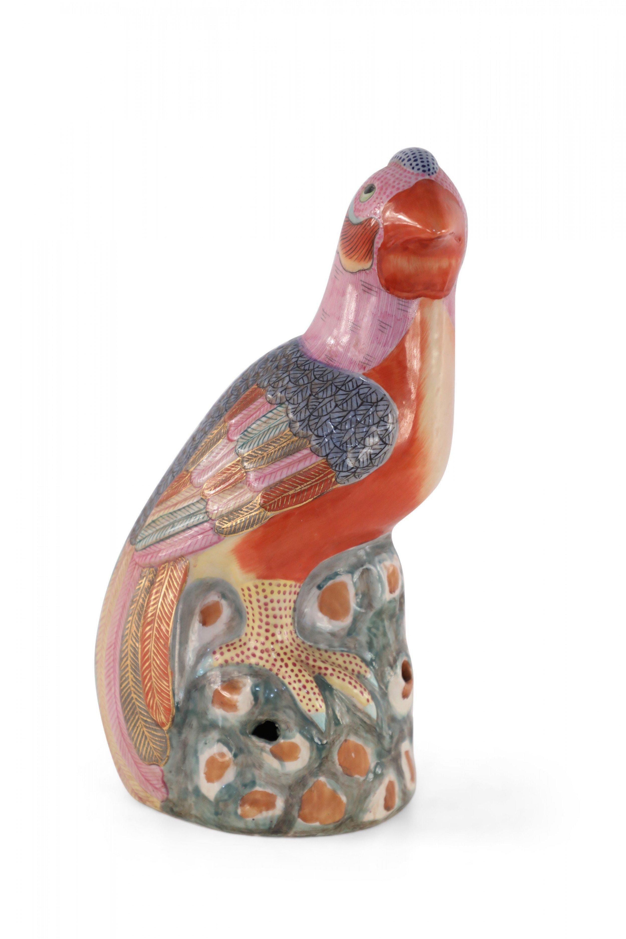 Antique Chinese (Mid 20th Century) glazed porcelain statue of a pheasant with colorful, gold-outlined plumes perched on a rocky formation of green and brown. (Smaller version available: NWL2187).