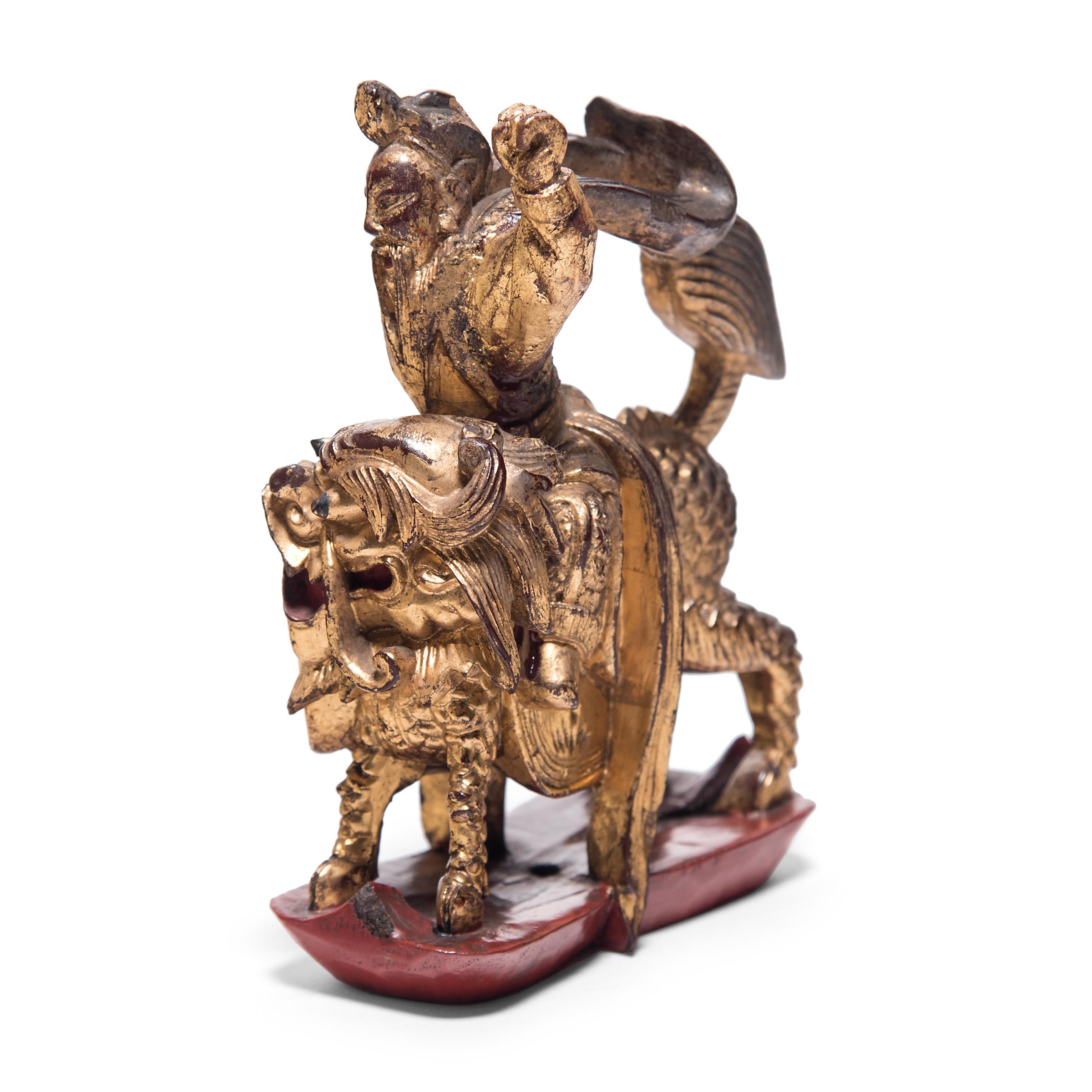 Lavishly pigmented and carved with intricate detail, this petite mythical figurine was originally a decorative element from an ornate 19th century bed surround. Riding a mythical qilin into battle, the figure depicts one of the hundreds of