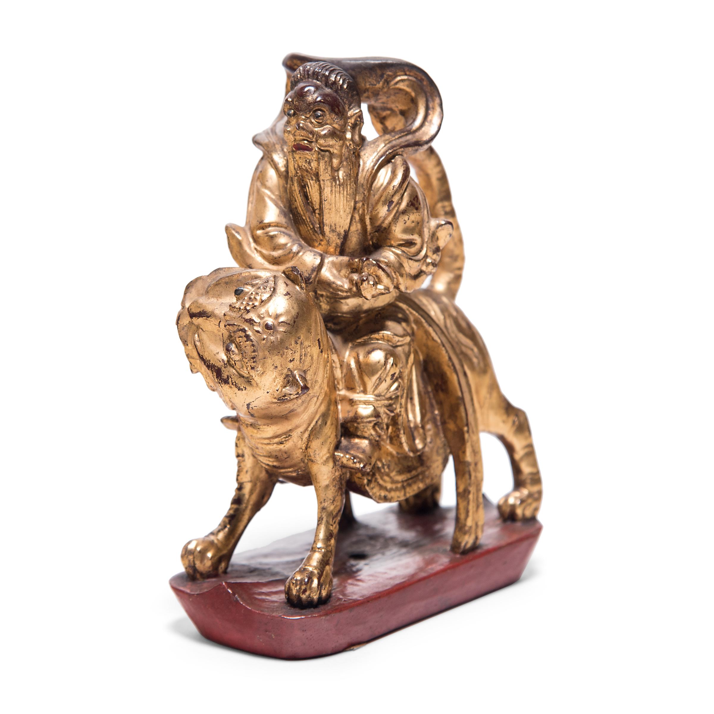 Lavishly pigmented and carved with intricate detail, this petite mythical figurine was originally a decorative element from an ornate 19th century bed surround. Dressed in flowing and riding on the back of a kingly lion, this elder figure depicts a