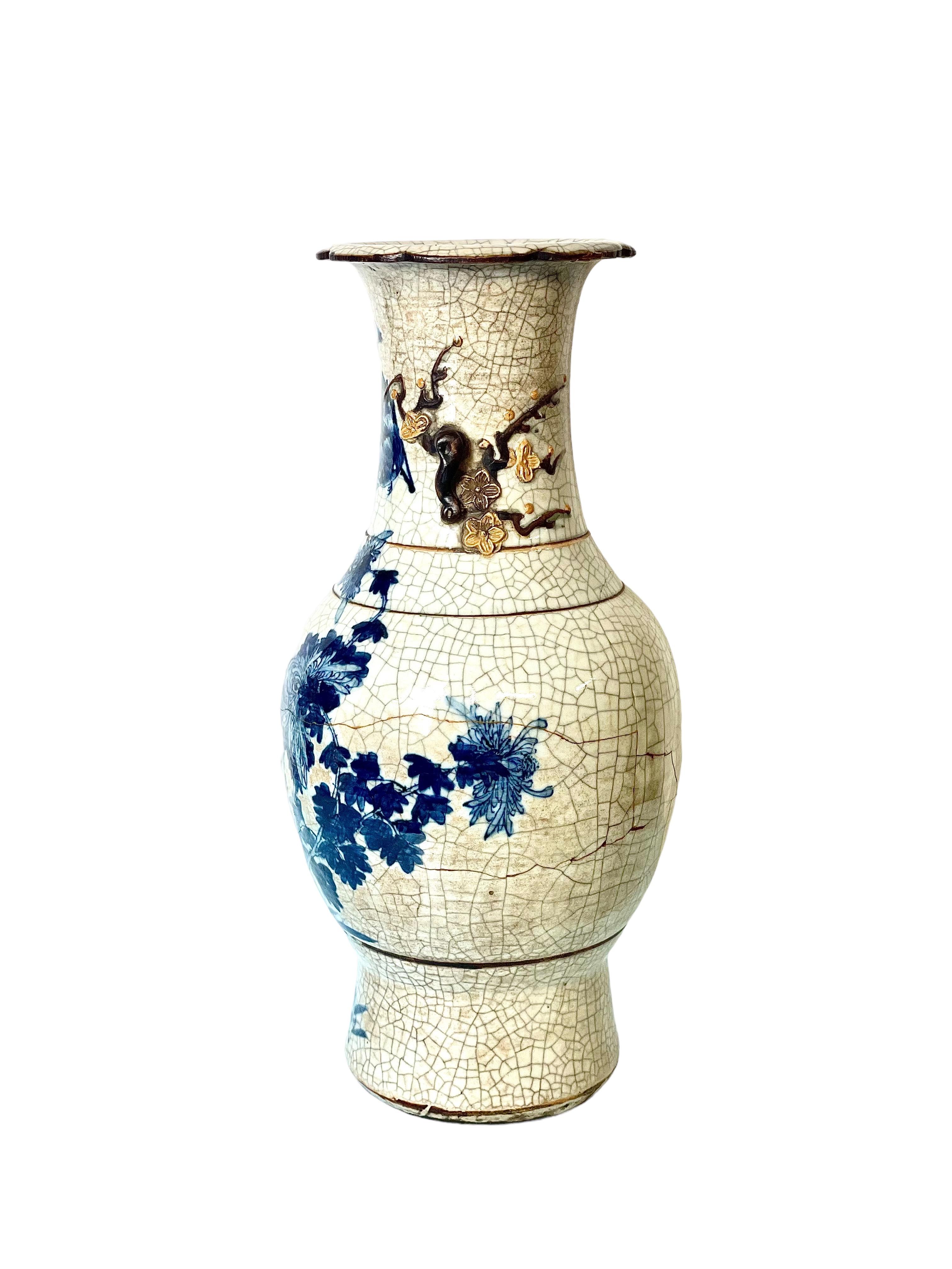 Full of character, this wonderful late 19th century Chinese Nanjing baluster vase features exquisite hand-painted decorations of birds and fish in vivid blue around its lower belly and reaching up around its neck. The white/beige background features