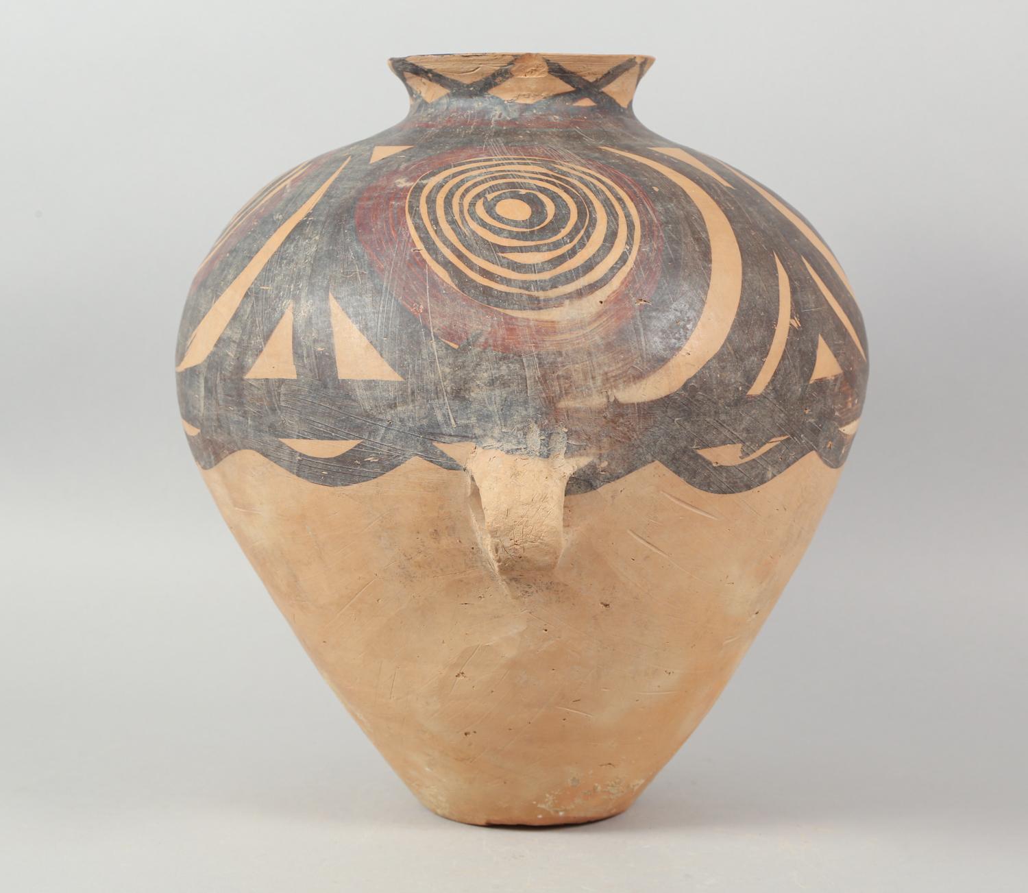 Chinese Neolithic Pottery Jar from the Majiayao Culture, specifically the Machang phase, in northwest China, and dating back roughly 4000 years. Jar is made from earthenware and painted with geometric red and brown circular motif. Jar has a