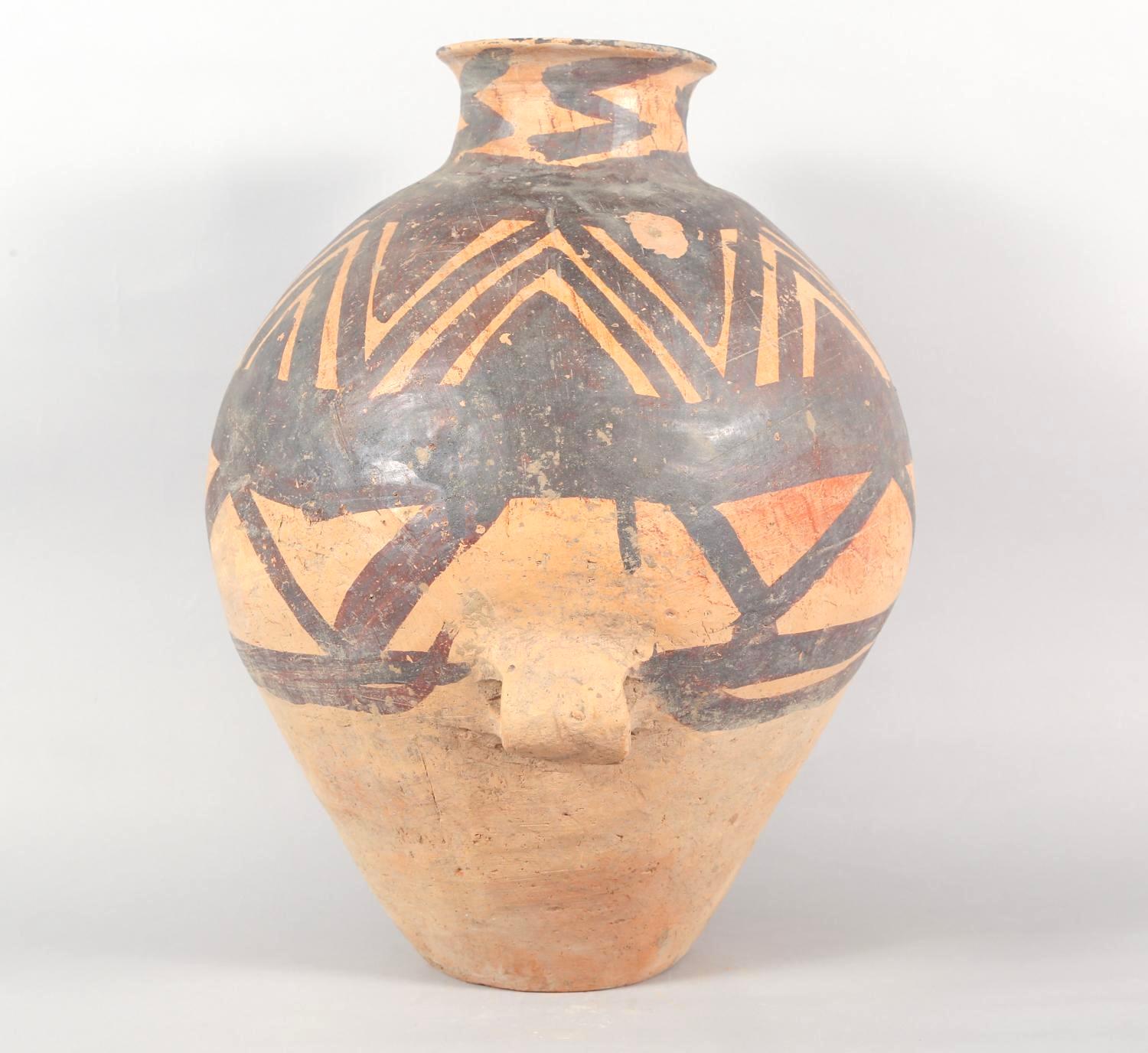 Chinese Neolithic Pottery Jar from the Majiayao Culture, specifically the Machang phase, in northwest China, and dating back roughly 4000 years. Jar is made from earthenware and painted with reddish-brown geometric motif. Jar has a pear-shaped body,