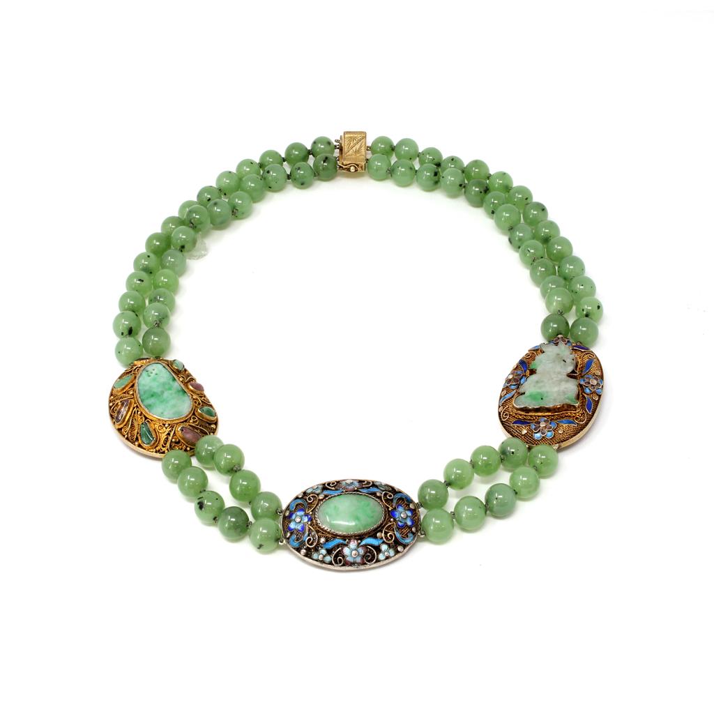 A Chinese double strands of nephrite jade necklace alternated with 3 spacers featuring Natural Jadeite jade carvings and cabochon on Vermeil. The nephrite jade beads measure 9 millimeters. The 3 spacers were originally created as brooches circa