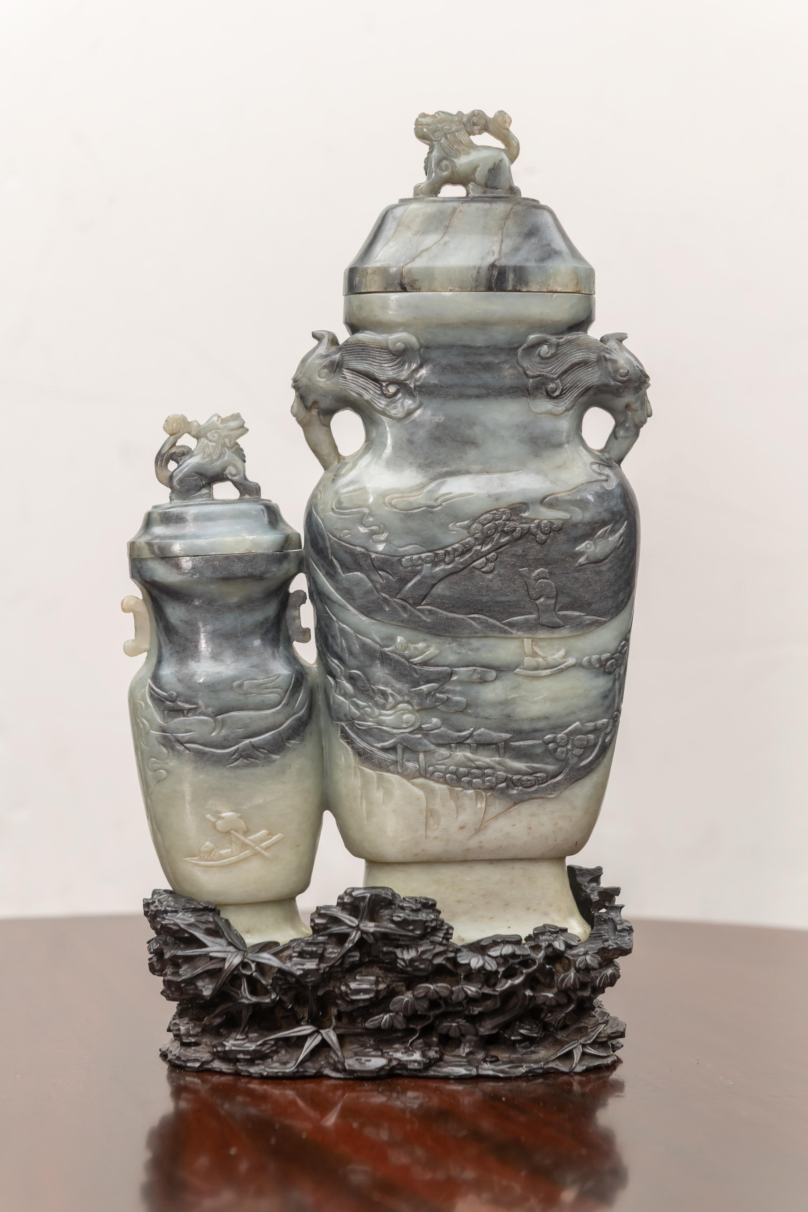 Chinese Nephrite / Jade of a relief carved double vase with old hardwood stand. Dramatic two color contrasting stone example. circa 1900. Classic landscape relief carved body with contrasting colors.
Comprised of two cap lids and an old hardwood